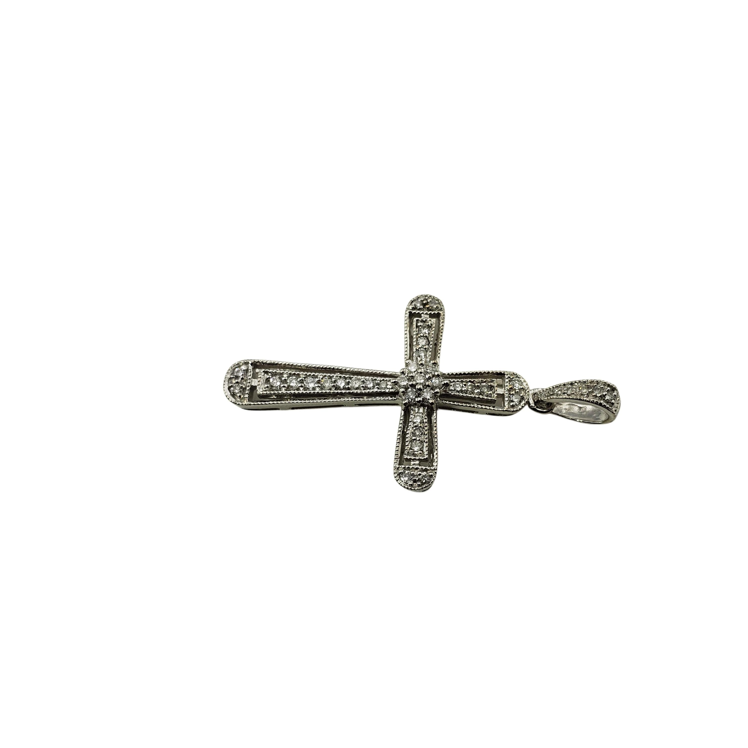 Vintage 14 Karat White Gold and Diamond Cross Pendant-

This sparkling cross pendant features 38 round brilliant cut diamonds set in classic 14K white gold.

Approximate total diamond weight:  .20 ct.

Diamond color:  G-H

Diamond clarity: 
