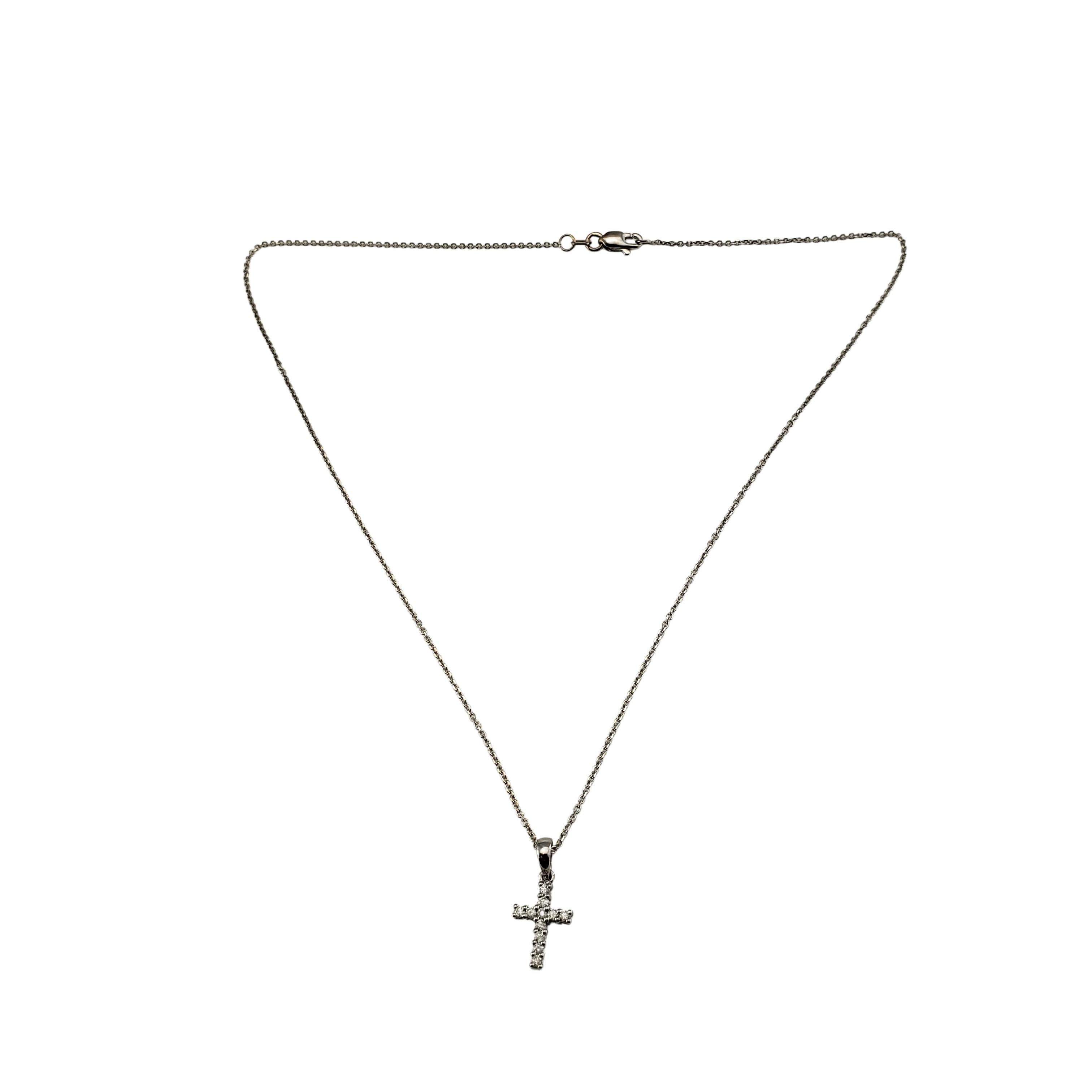 Vintage 14 Karat White Gold and Diamond Cross Pendant Necklace-

This sparkling cross pendant features 11 round brilliant cut diamonds set in classic 14K gold. Suspends from a classic cable chain.

Approximate total diamond weight: .12 ct.

Diamond