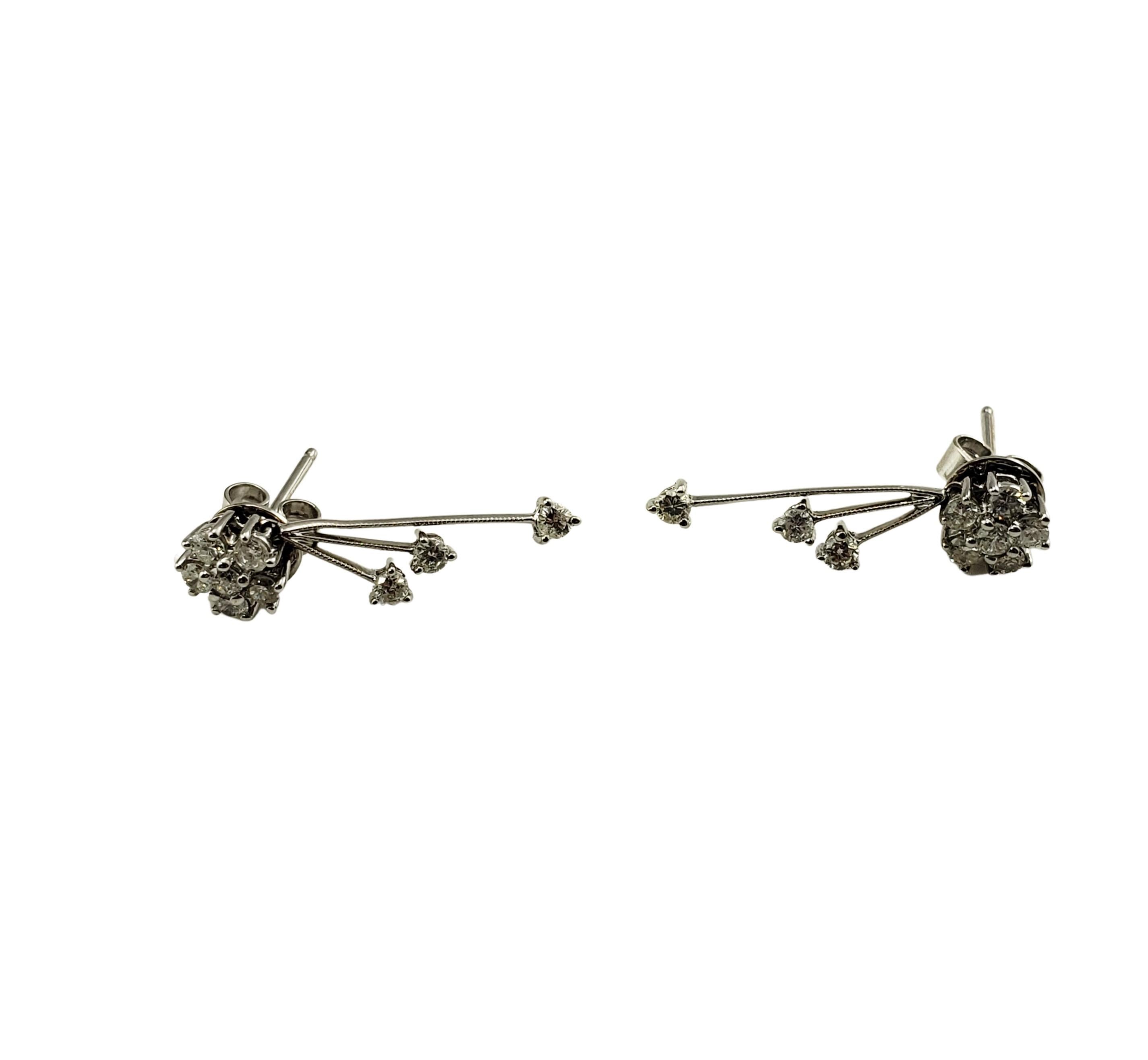 Vintage 14 Karat White Gold and Diamond Dangle Earrings-

These sparkling earrings each feature nine round brilliant cut diamonds set in classic 14K white gold.  Push back closures.

Approximate total diamond weight:  .66 ct.

Diamond color: