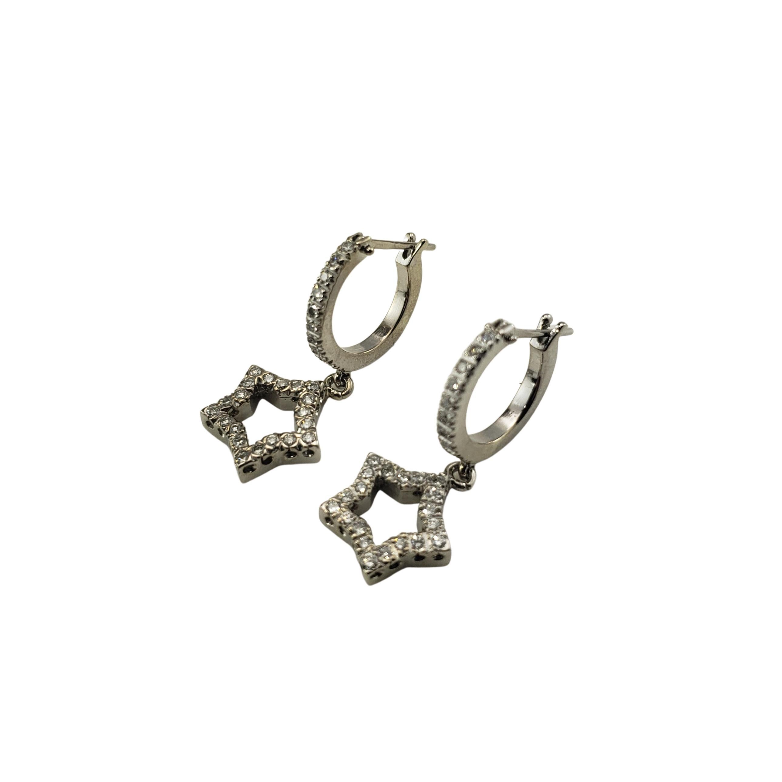 Vintage 14 Karat White Gold and Diamond Hoop and Star Earrings-

These sparkling hoop earrings with dangling stars each feature 30 round brilliant cut diamonds set in classic 14K white gold.

Approximate total diamond weight:  .60 ct.

Diamond
