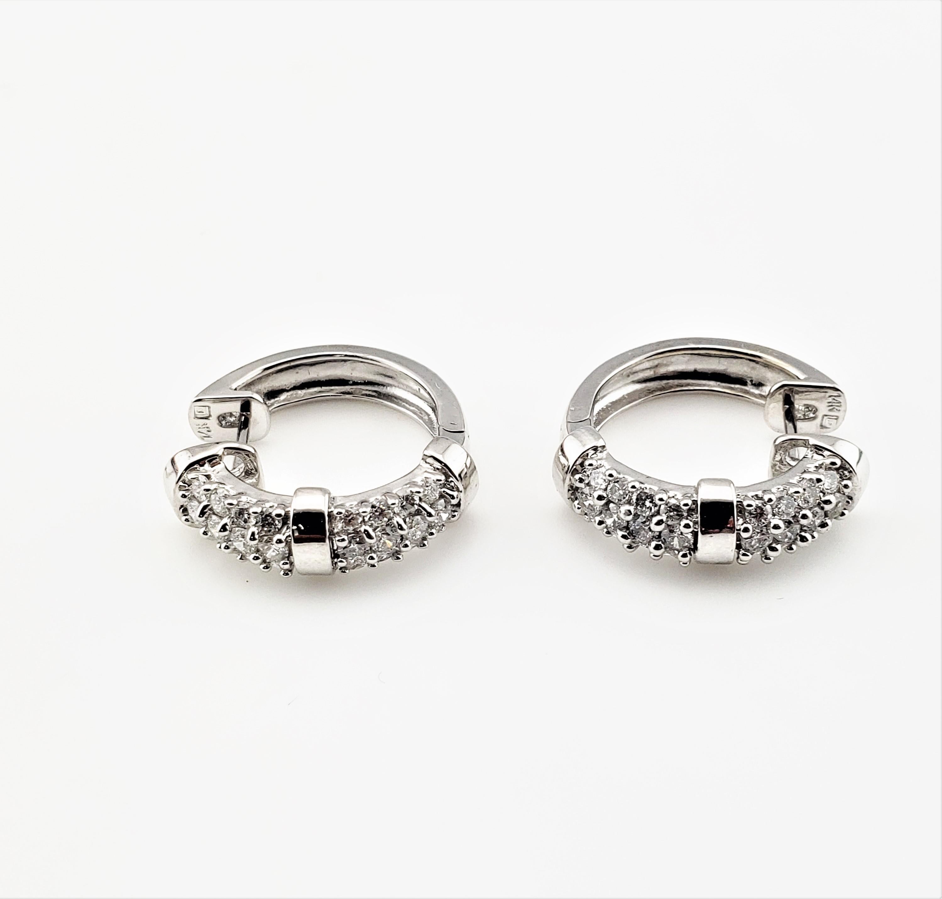 Vintage 14 Karat White Gold and Diamond Hoop Earrings-

These sparkling hinged hoop earrings each feature 24 round brilliant cut diamonds set in beautifully detailed 14K white gold.
Width: 5 mm.

Approximate total diamond weight: .72 ct.

Diamond