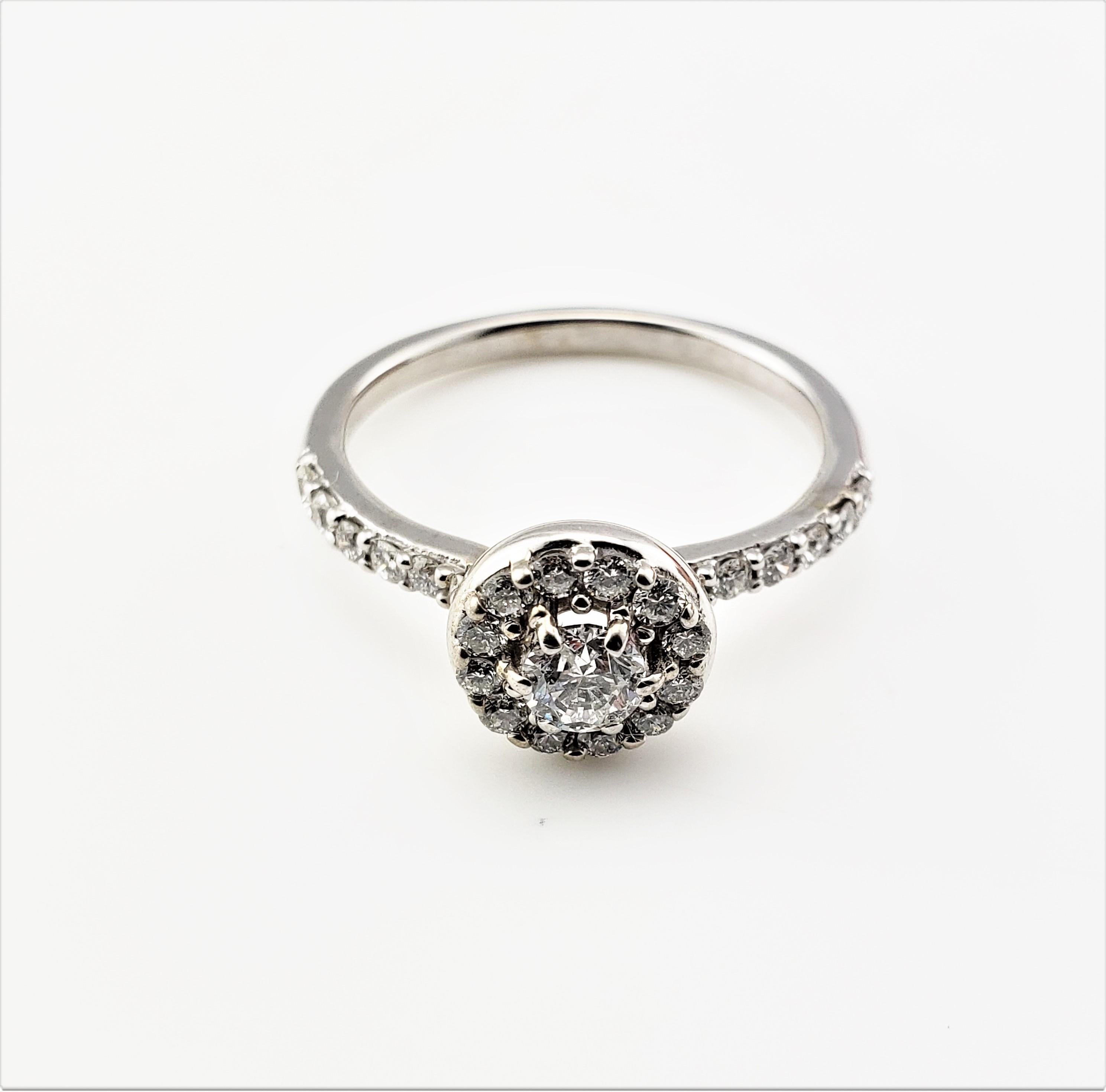 Vintage 14 Karat White Gold and Diamond Ring Size 8.5-

This sparkling ring features 25 round brilliant cut diamonds (center .27 ct.), halo and band (.48 tcw.) set in beautifully detailed 14K white gold. Shank: 2 mm. Top of ring measures 9