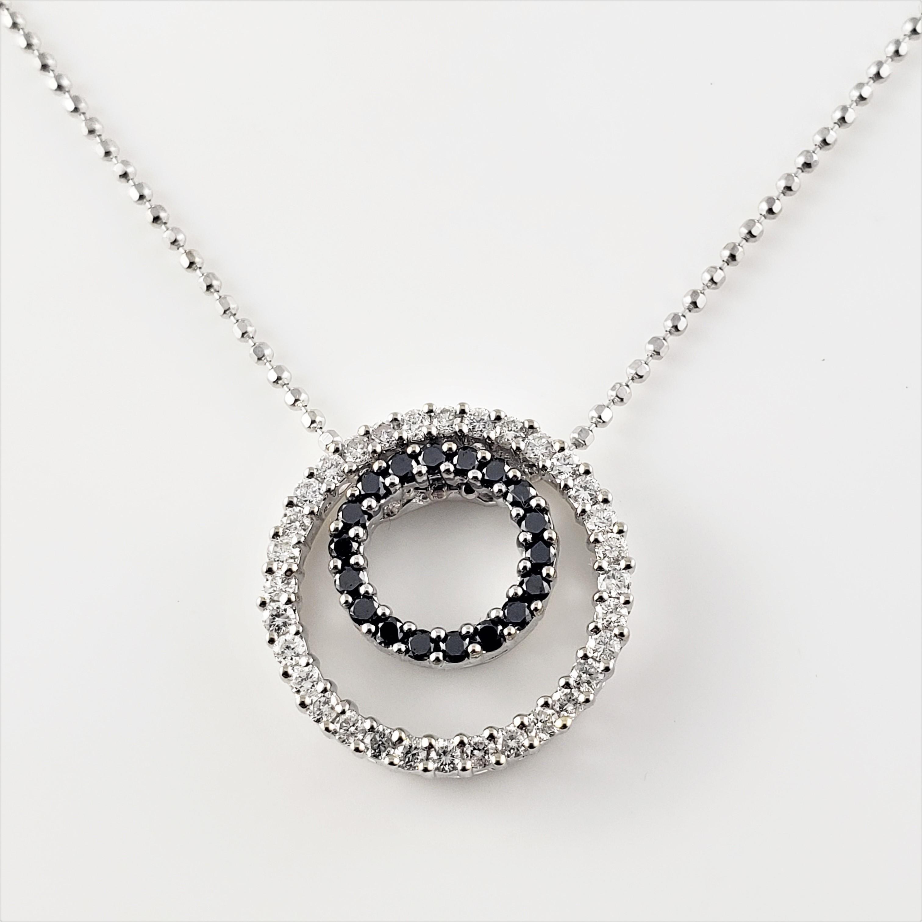Vintage 14 Karat White Gold Black and White Diamond Circle Necklace-



This lovely necklace features 18 round black diamonds (.18cts)  and 32 (.32cts) round brilliant cut diamonds set in elegant 14K white gold.  Suspends from a 14K white gold