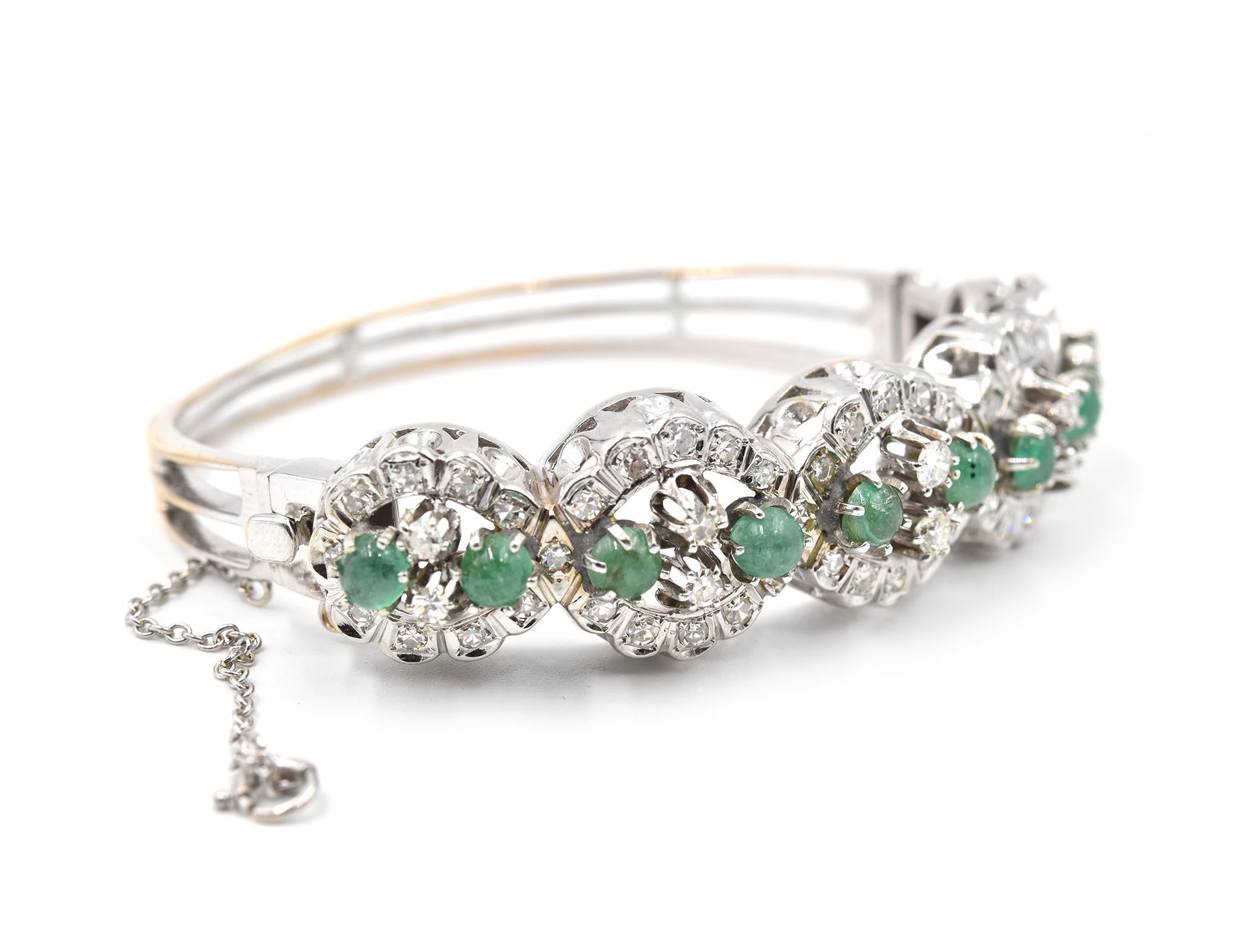 Designer: custom design
Material: 14k white gold
Emerald: 10 round emerald cabochons = 4.00ct
Diamonds: 52 round diamonds= 1.04cttw
Color: G	
Clarity: VS
Dimensions: bangle will fit 7-inch wrist and 16mm wide
Weight: 36.3 grams
