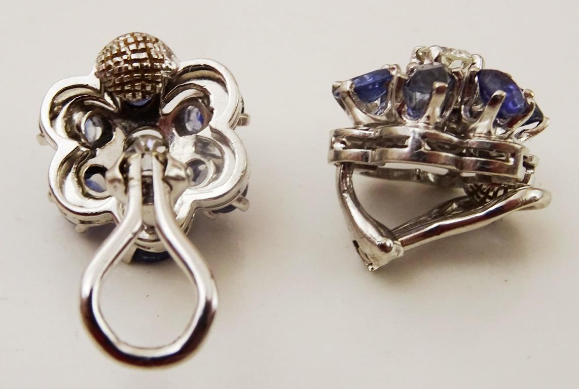 A pair of vintage / antique earrings , by the design and the cut of the stones they come from the early part of the 20th century.
In the shape of a cluster / flower.
The central stone is a Old European Cut Diamond of about 3.5 mm round, total weight