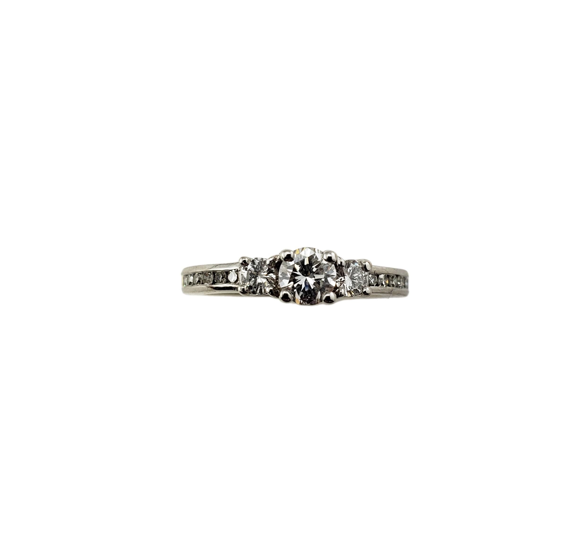 14 Karat White Gold Diamond Engagement Ring Size 6-

This sparkling ring features three round brilliant cut diamonds (center: .32 ct.) and 16 round single cut diamonds set in classic 14K white gold.  

Shank: 2 mm.

Approximate total diamond weight: