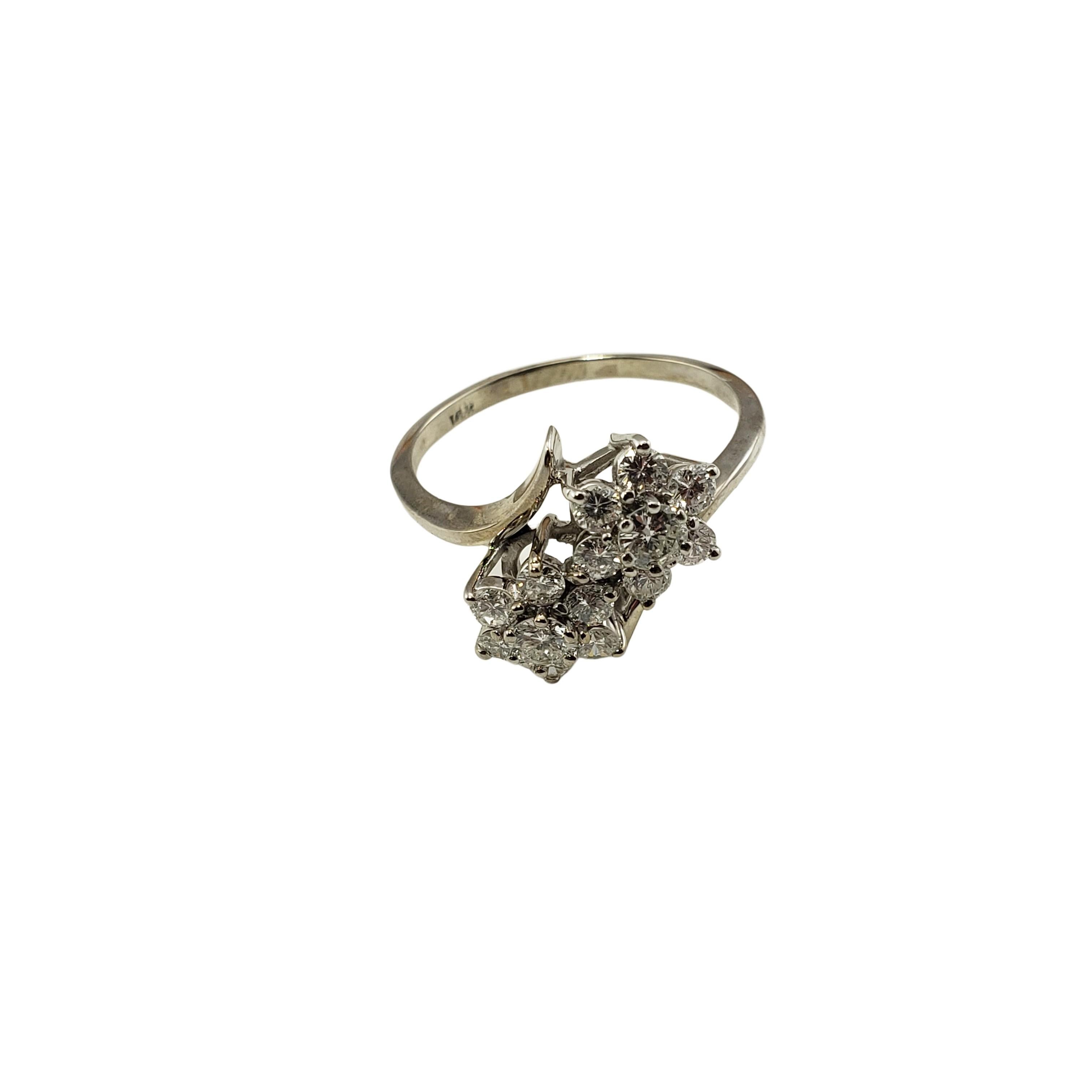 Vintage 14 Karat White Gold Diamond Flower Ring Size 9-

This sparkling flower ring features 14 round brilliant cut diamonds set in classic 14K white gold.  Width:  12 mm.  Shank:  1.5 mm.

Approximate total diamond weight:  1.05 ct.

Diamond color:
