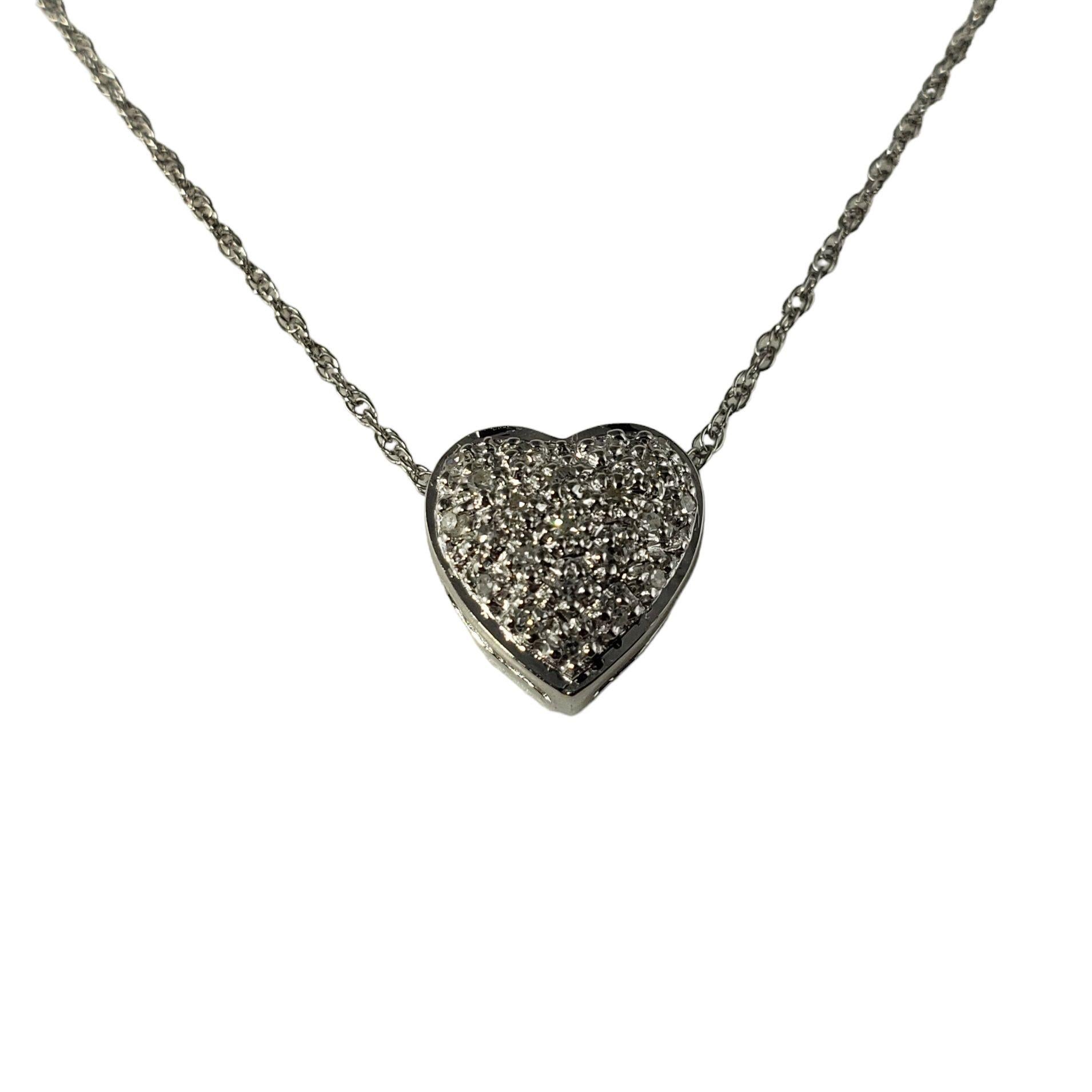 Vintage 14 Karat White Gold and Diamond Heart Pendant Necklace-

This sparkling heart pendant necklace features 15 round single cut diamonds set in beautifully detailed 14K white gold.

Approximate total diamond weight:  .15 ct.

Diamond clarity: