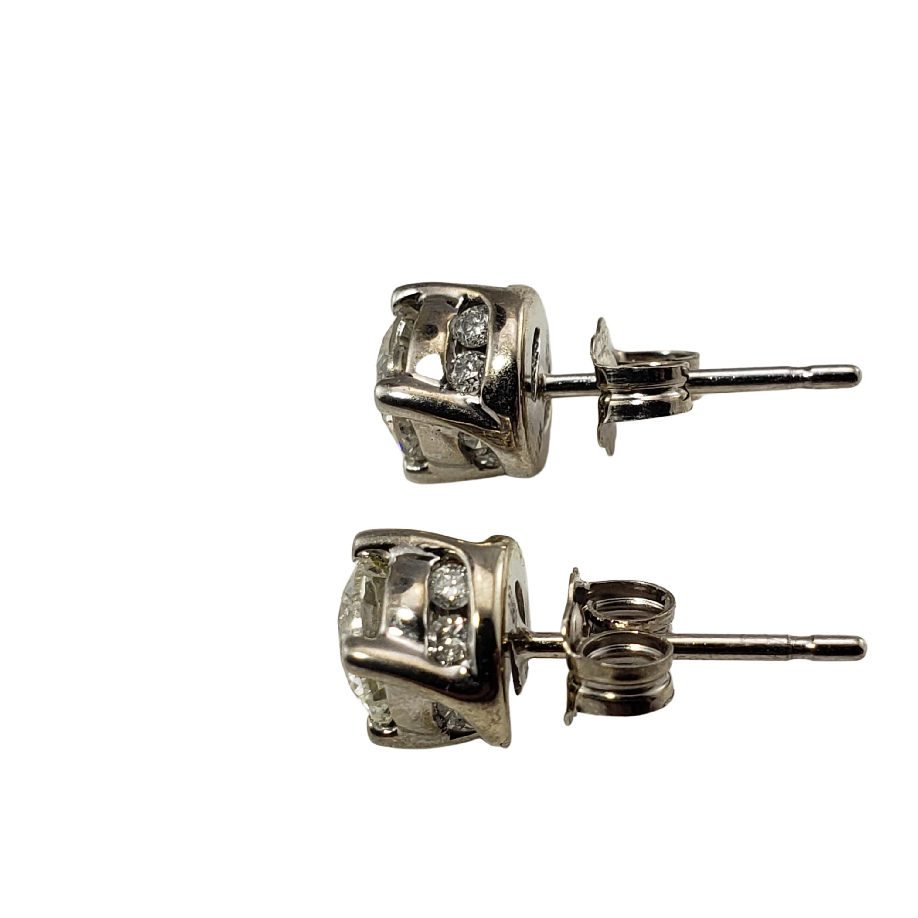 Vintage 14 Karat White Gold Diamond Stud Earrings .94 TCW.-

These sparkling earrings each feature one center round brilliant cut diamond in a diamond encrusted setting .  Push back closures.

Approximate total diamond weight:  .94 ct.  (.78 TCW.
