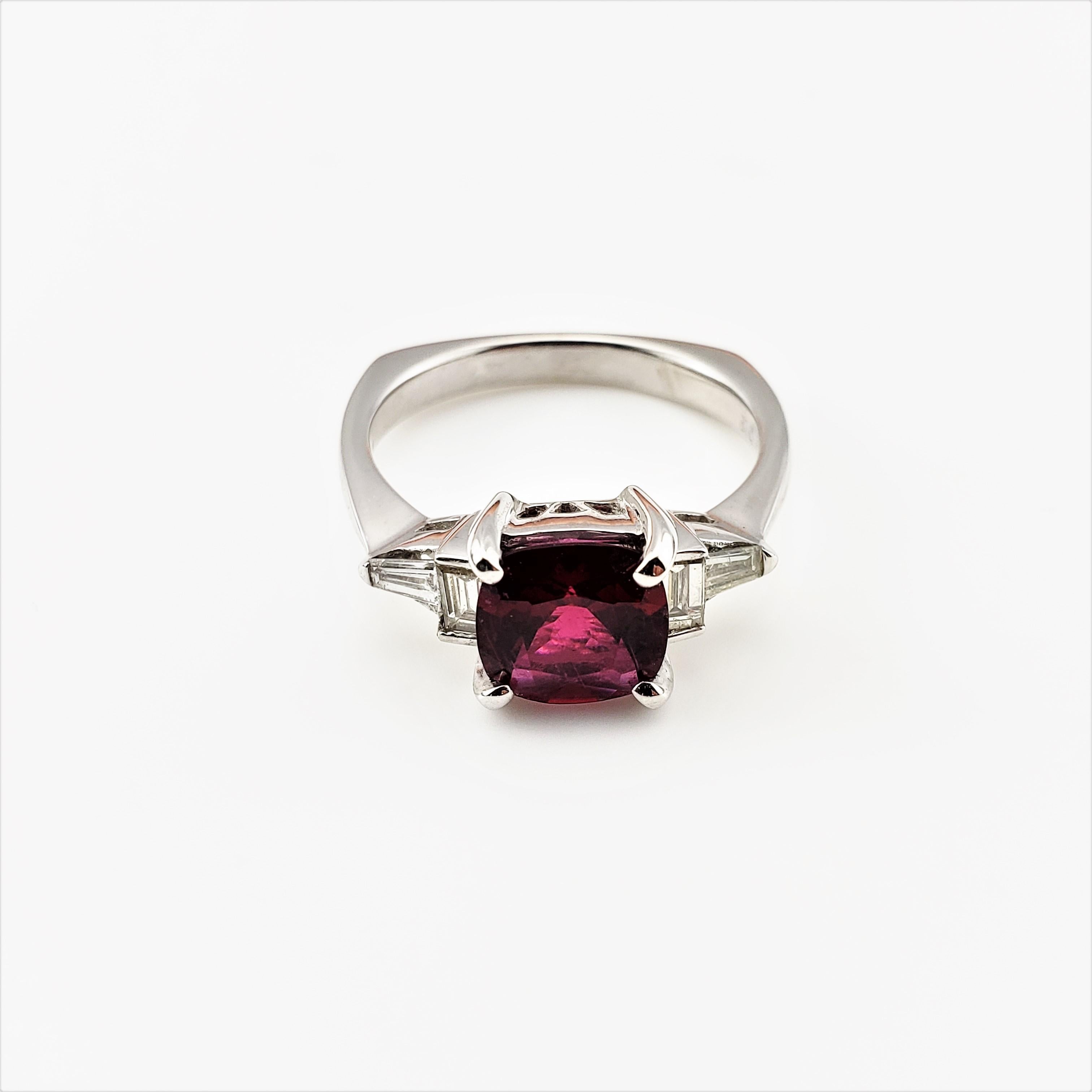 Vintage 14 Karat White Gold Garnet and Diamond Ring Size 9 GAI Certified-

This stunning ring features one cushion cut red garnet (8 mm x 8 mm) and four baguette diamonds set in elegant 14K white gold.
Shank:  3 mm.

Total diamond weight:  .60