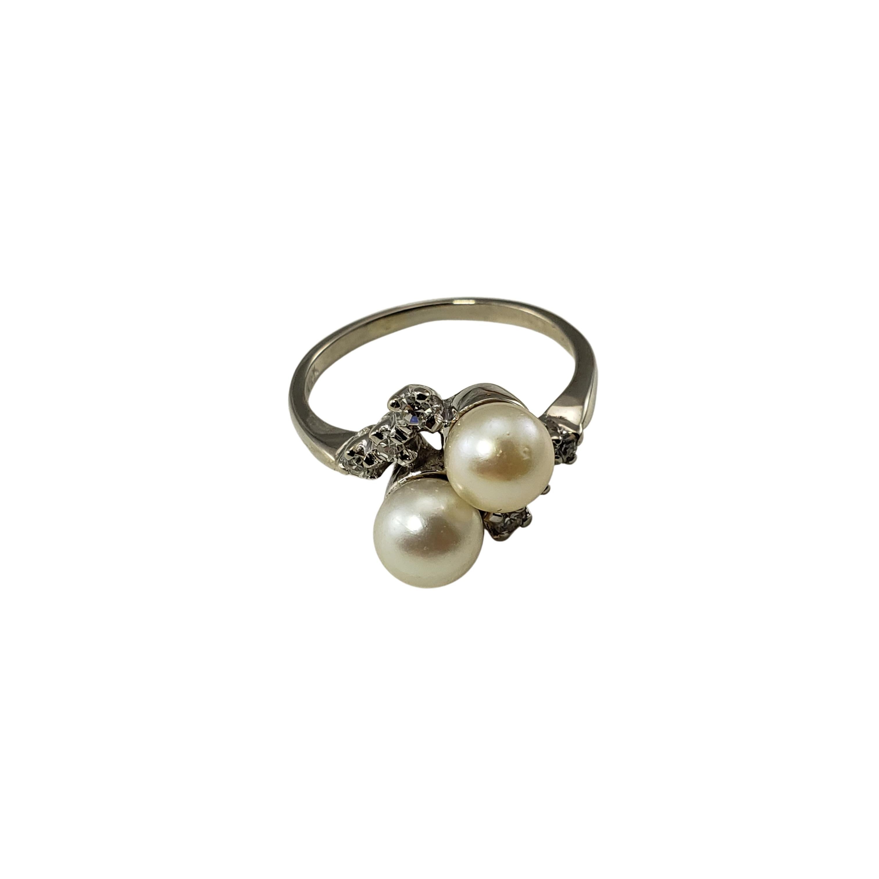 Vintage 14 Karat White Gold Pearl and Diamond Ring Size 8.25-

This elegant ring features two white pearls (6 mm each) and six round single cut diamonds set in classic 14K white gold.
Shank: 1.5 mm.

Approximate total diamond weight: .14