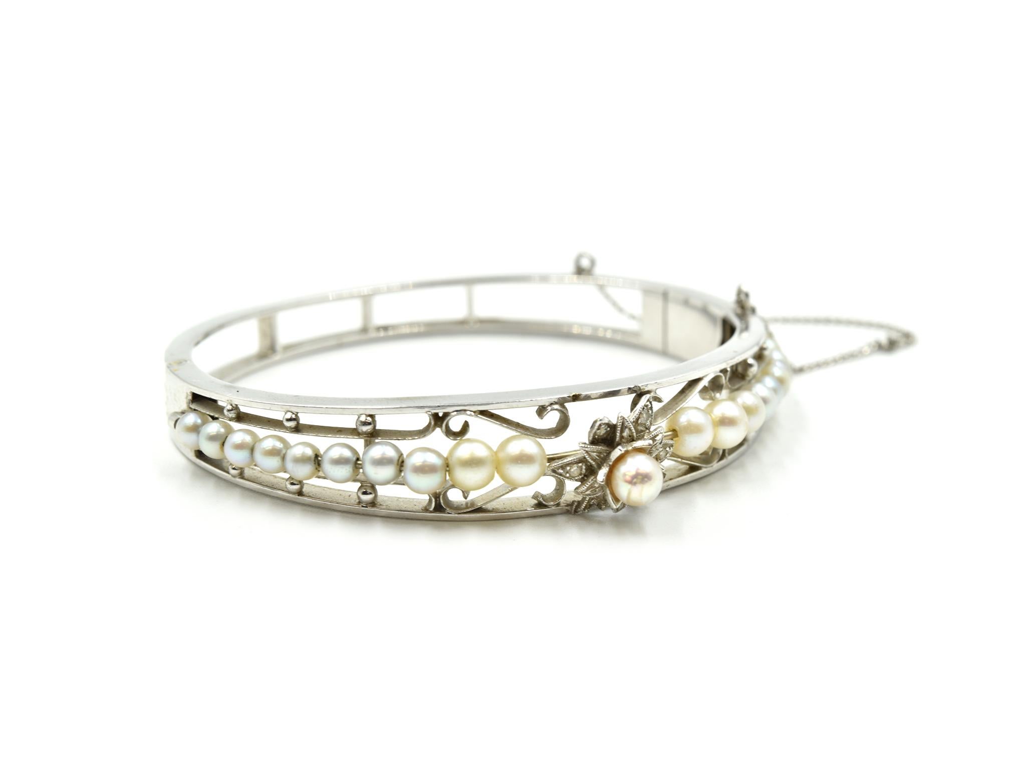 Designer: custom design
Material: 14k white gold
Pearls: round 3.40mm-4.40mm cultured pearls
Dimensions: bracelet will fit up to 6-inch wrist and is 3/8-inch wide, with 3-inch safety chain
Weight: 17.08 grams
