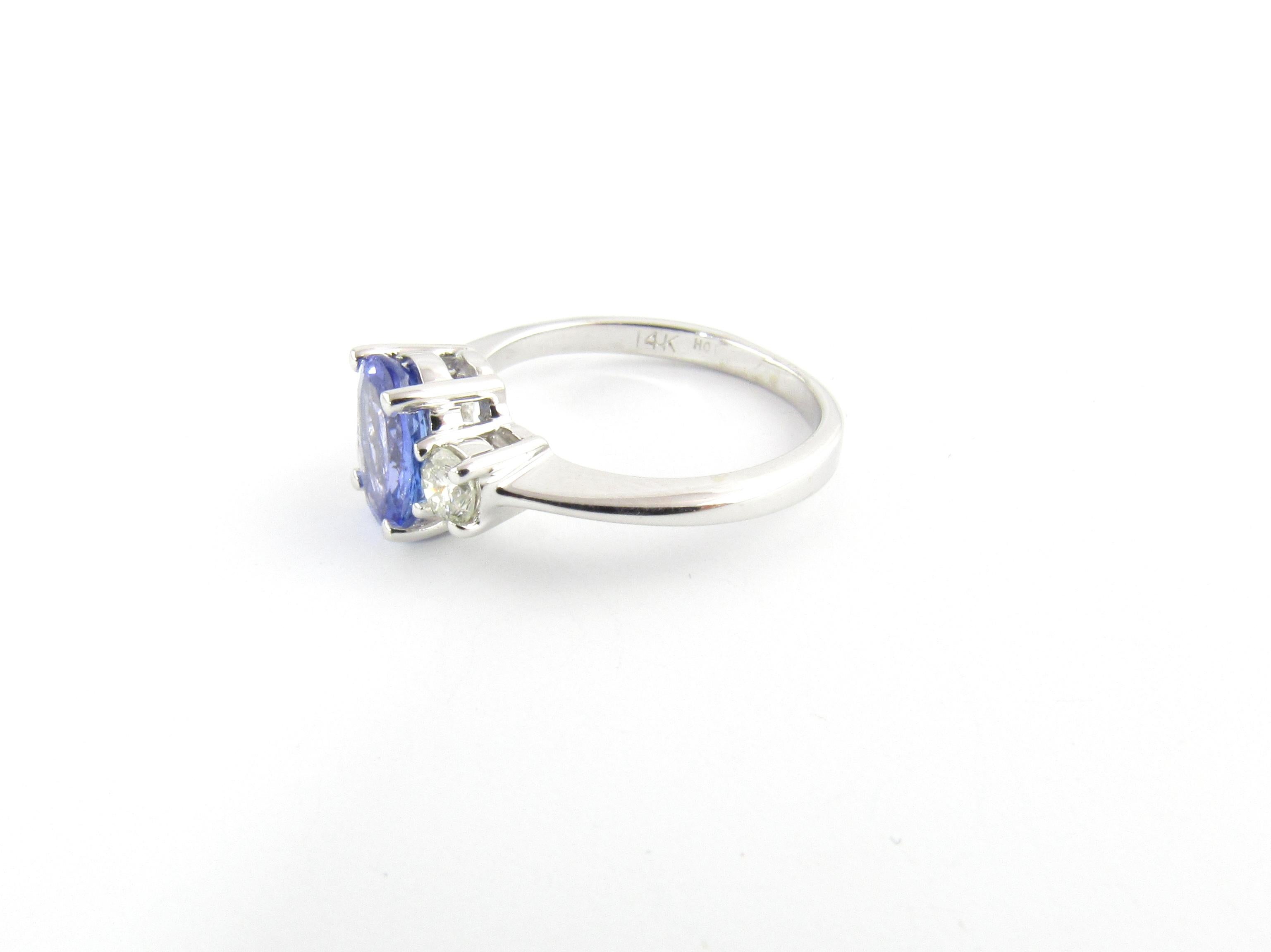 Vintage 14 Karat White Gold Tanzanite and Diamond Ring Size 5.25-

This lovely ring features one oval tanzanite (8 mm x 7 mm) and two round brilliant cut diamonds set in classic 14K white gold. Shank measures 2 mm.

Comes with Gemological Appraisal