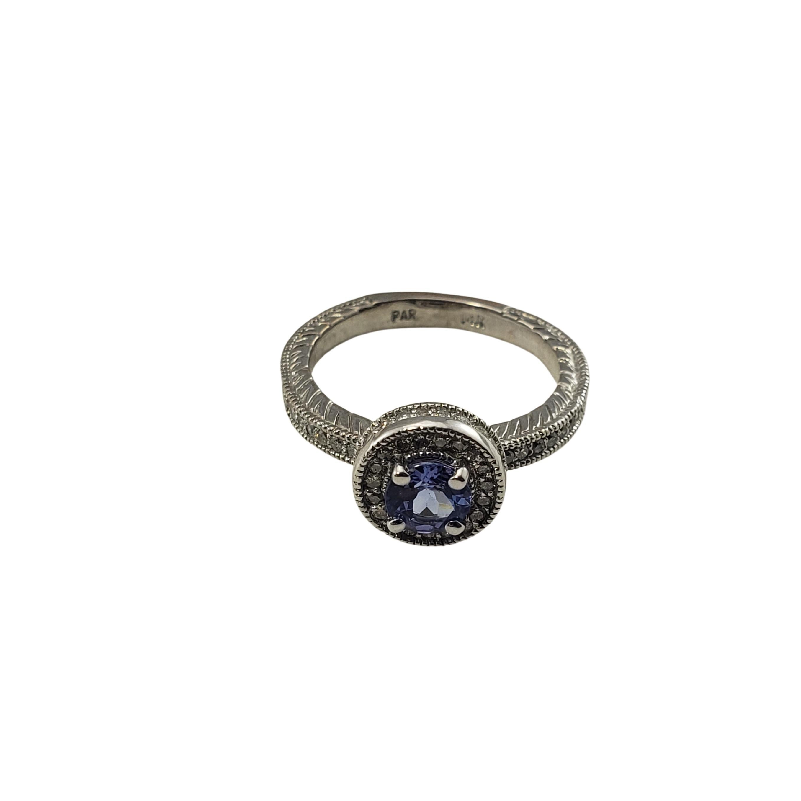 Vintage 14 Karat White Gold Tanzanite and Diamond Ring Size 7-

This elegant ring features one round tanzanite (5 mm) and 32 round brilliant cut diamonds set in classic 14K white gold.  
Width:  10 mm.  Shank: 3 mm.

Approximate total diamond