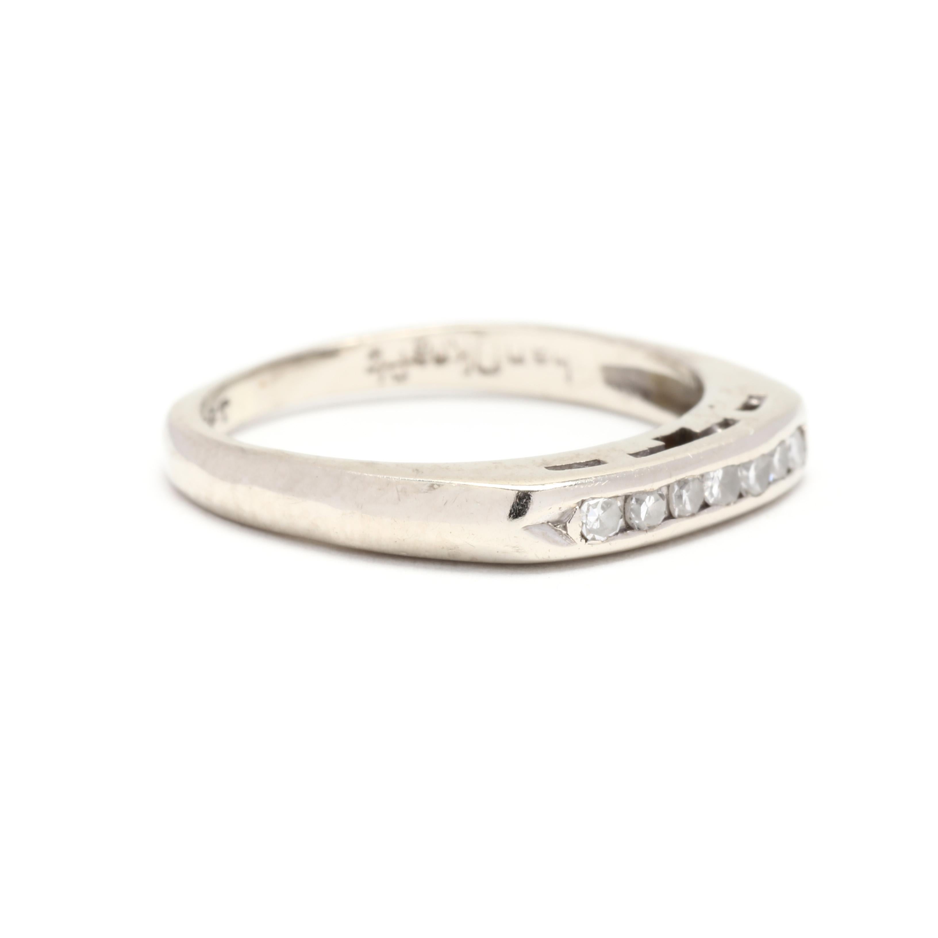 A vintage 14 karat white gold diamond band. This stackable band features seven channel set, single cut round diamonds weighing approximately .08 total carats and with a tapered band.



Stones:

- diamonds, 7 stones

- single cut round

- 1.5 mm

-