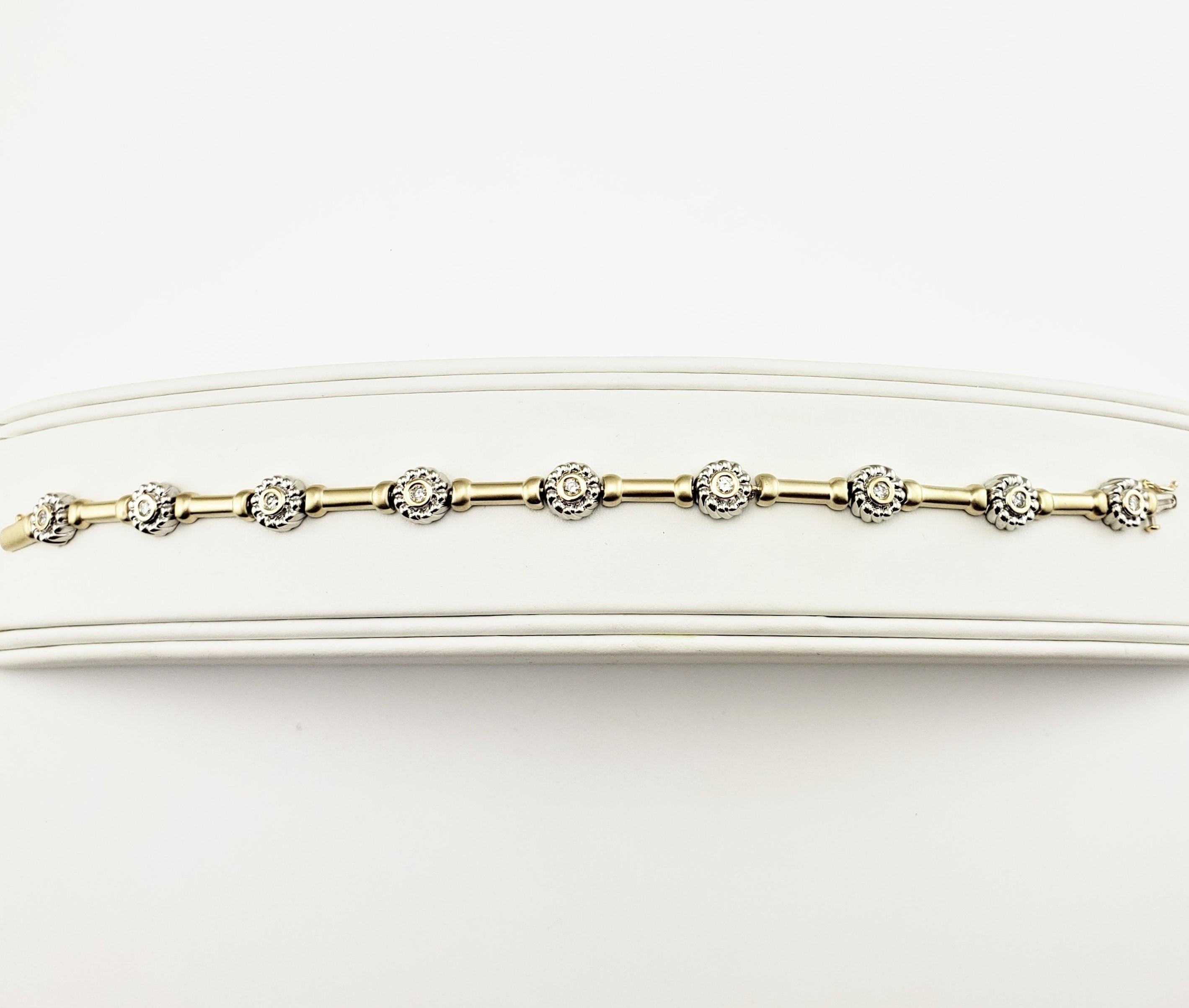 Vintage 14 Karat Yellow and White Gold Diamond Bracelet-

This stunning 14K yellow and white gold bracelet features nine round brilliant cut diamonds set in a lovely floral design.
Width: 8 mm.

Approximate total diamond weight: .45 ct.

Diamond