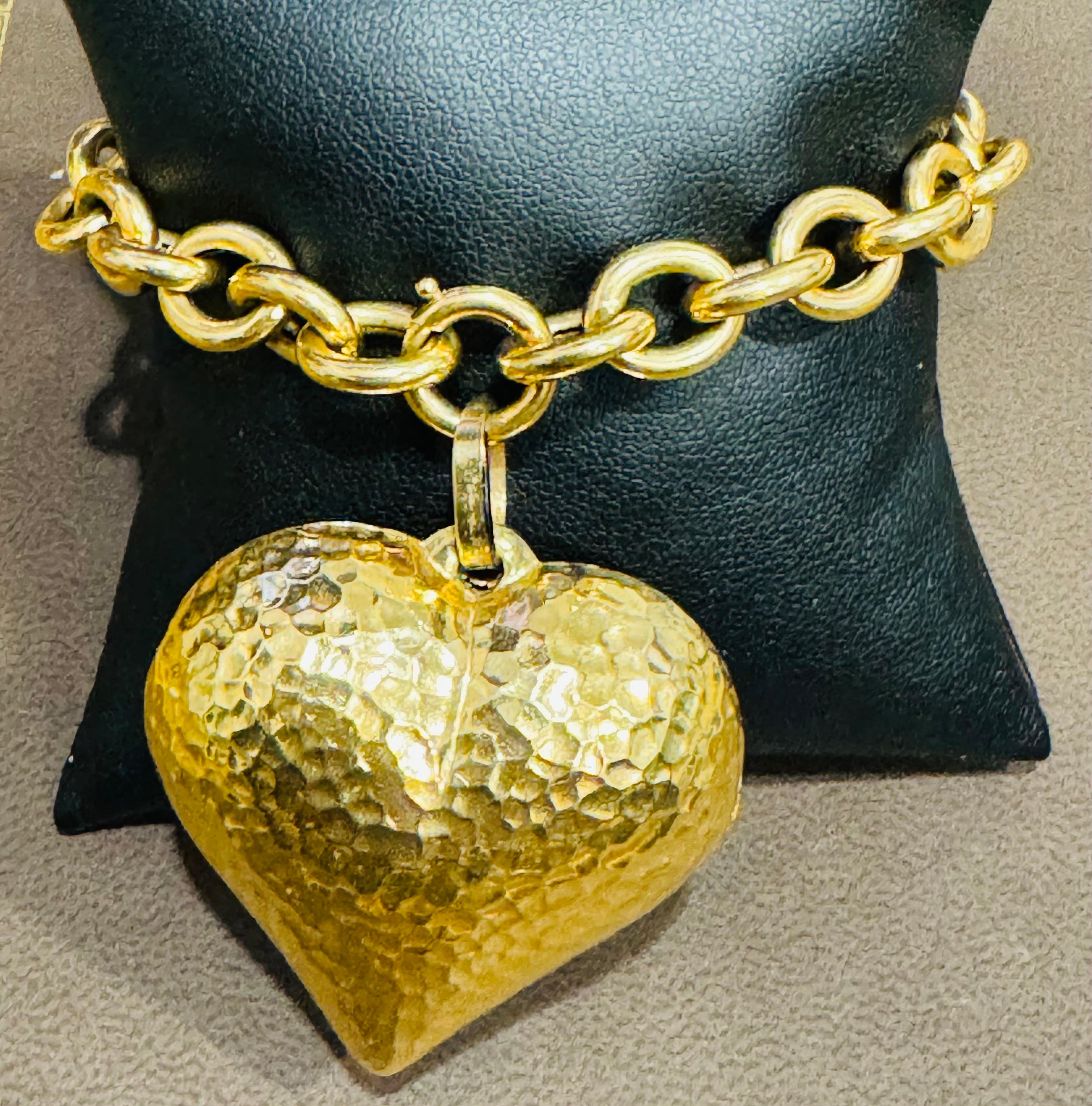 Solid 14 karat gold
Vintage 14 Karat Yellow Gold 24.3 Gm Link Bracelet for Charms with Huge Heart Charm
14 Karat Yellow  Gold Bracelet made of authentic solid gold.  It is  nicely polished and stamped 
stamped 585
Heart is 1.5 inch wide and 1.5 inch