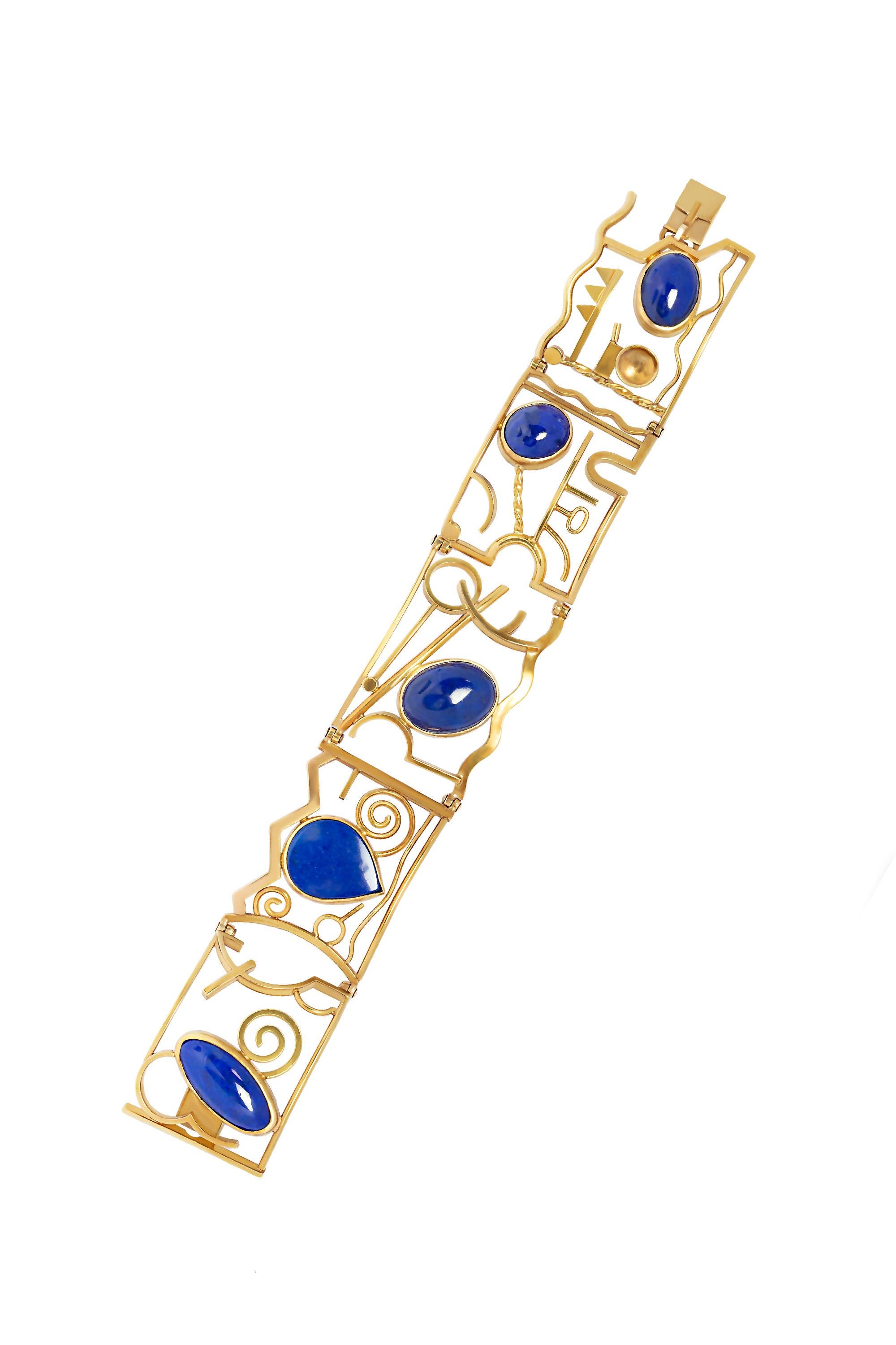 A modern abstract design bracelet with Lapis Lazuli. Handcrafted in 14 karat yellow gold.  Measures 7“ in length. Stamped 14K S.A Shaw