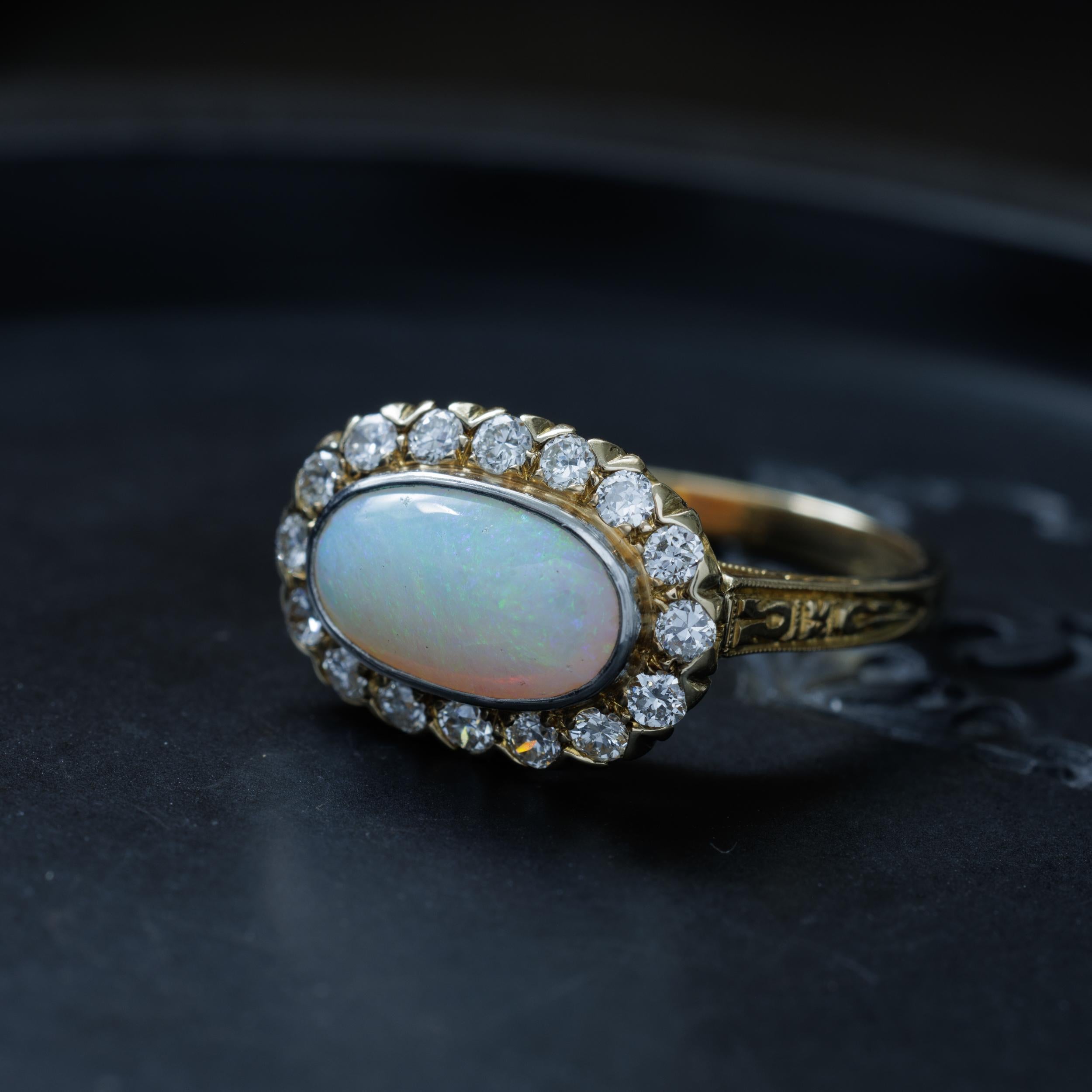Vintage 14 Karat Yellow Gold and 1.8 Carat Opal Ring with 0.90 Carats Old European Cut Diamonds

H 1.2 cm x W 1.7 cm / 0.472 in. x 0.669 in
4 grams

Size 7.5 (sizable)