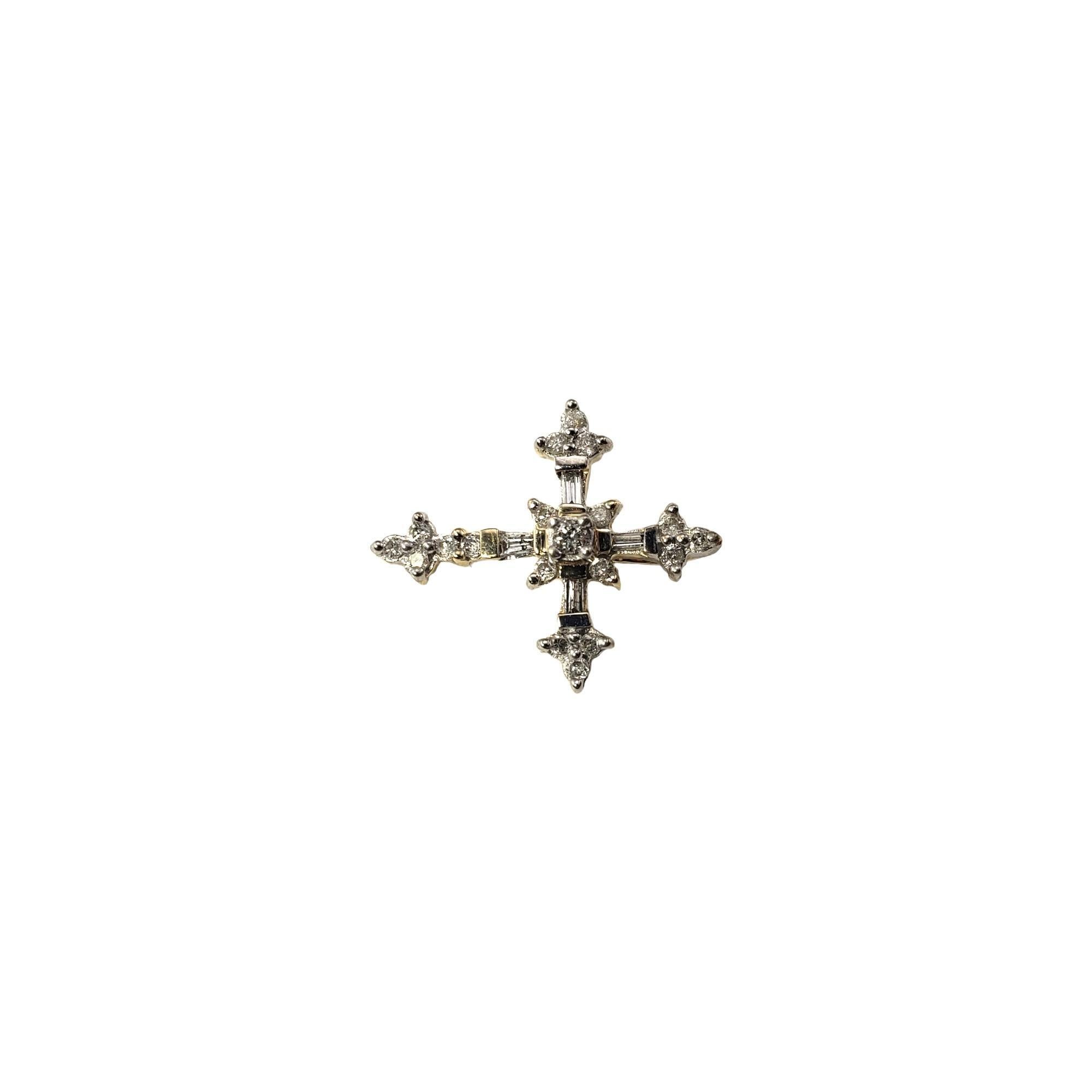 Vintage 14 Karat Yellow Gold and Diamond Cross Pendant-

This sparkling cross pendant features four baguette diamonds and 17 round brilliant cut diamonds set in classic 14K yellow gold.

*Chain not included.

Approximate total diamond weight:  .28