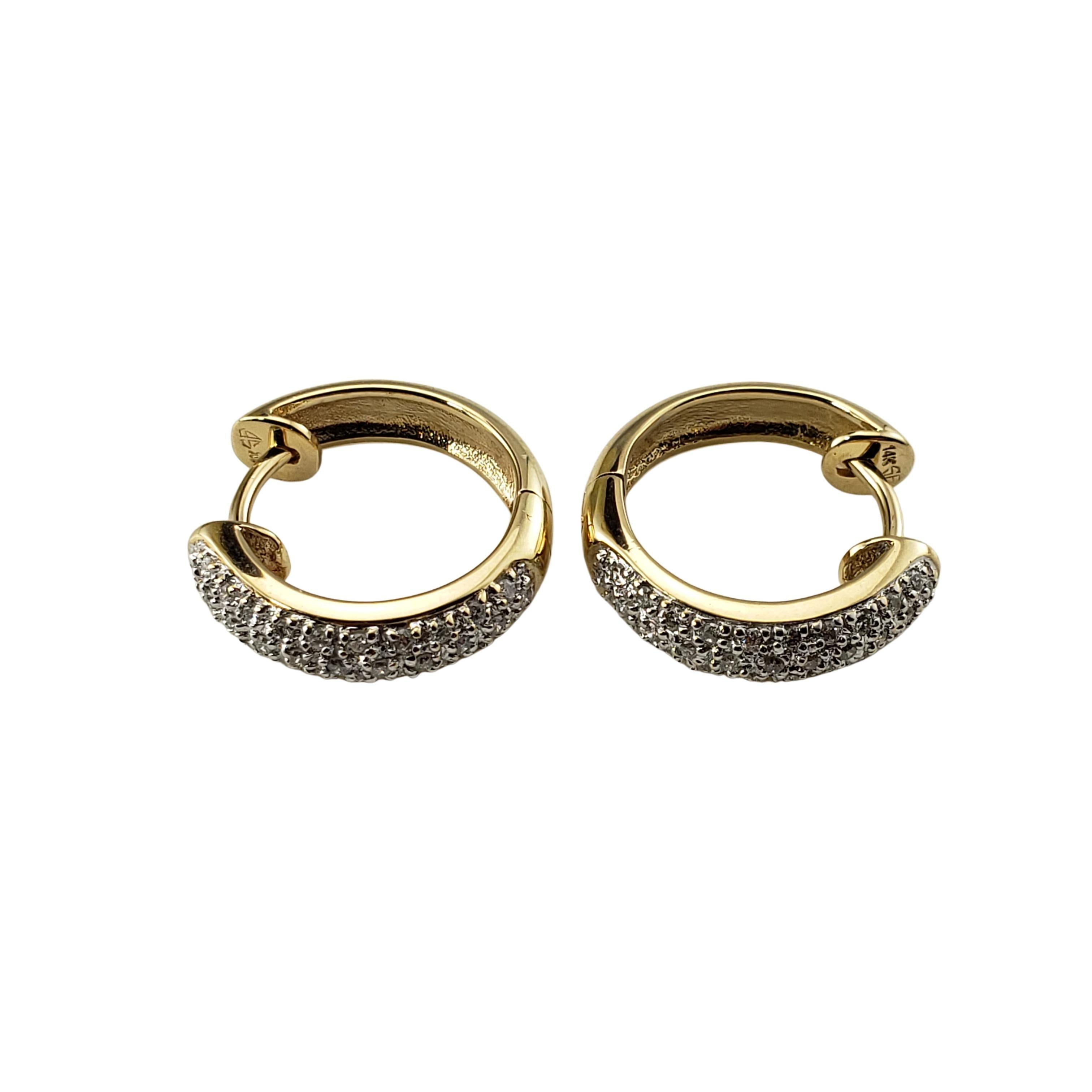 Vintage 14 Karat Yellow Gold and Diamond Hoop Earrings-

These sparkling earrings each feature 31 round brilliant cut diamonds set in classic 14K yellow gold.  

Approximate total diamond weight:  .40 ct.

Diamond color:  I-J

Diamond clarity: 