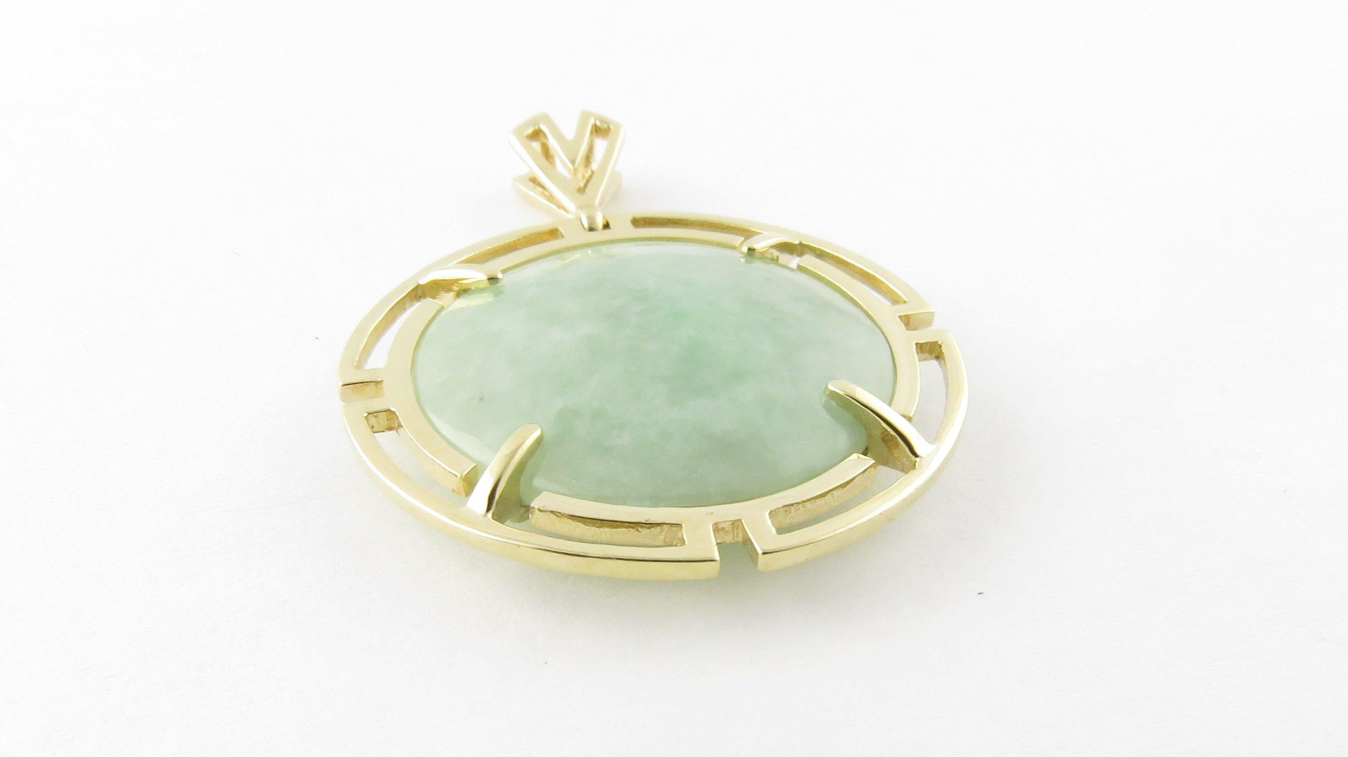 Vintage 14 Karat Yellow Gold and Jade Pendant- 
This lovely pendant features one round light green jade stone (21 mm) framed in beautifully detailed 14K yellow gold. 
Size: 37 mm x 29 mm 
Weight: 5.3 dwt. / 8.3 gr. 
Hallmark: HK 14K 
Very good