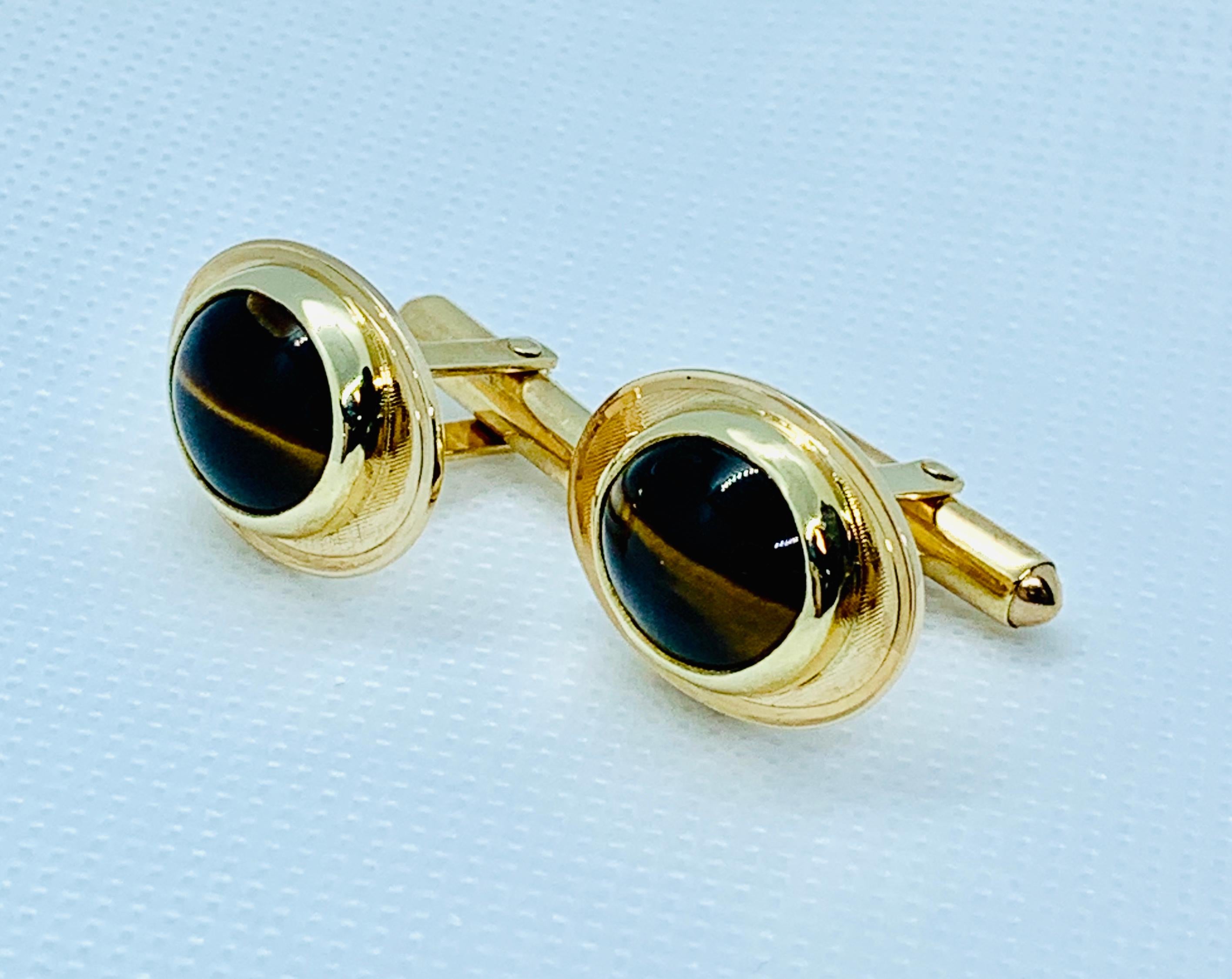 Very Handsome Tiger's Eye Cufflinks! These feature oval Tiger's Eye Center stones that are set in solid 14k yellow gold links that have a florentine finish.