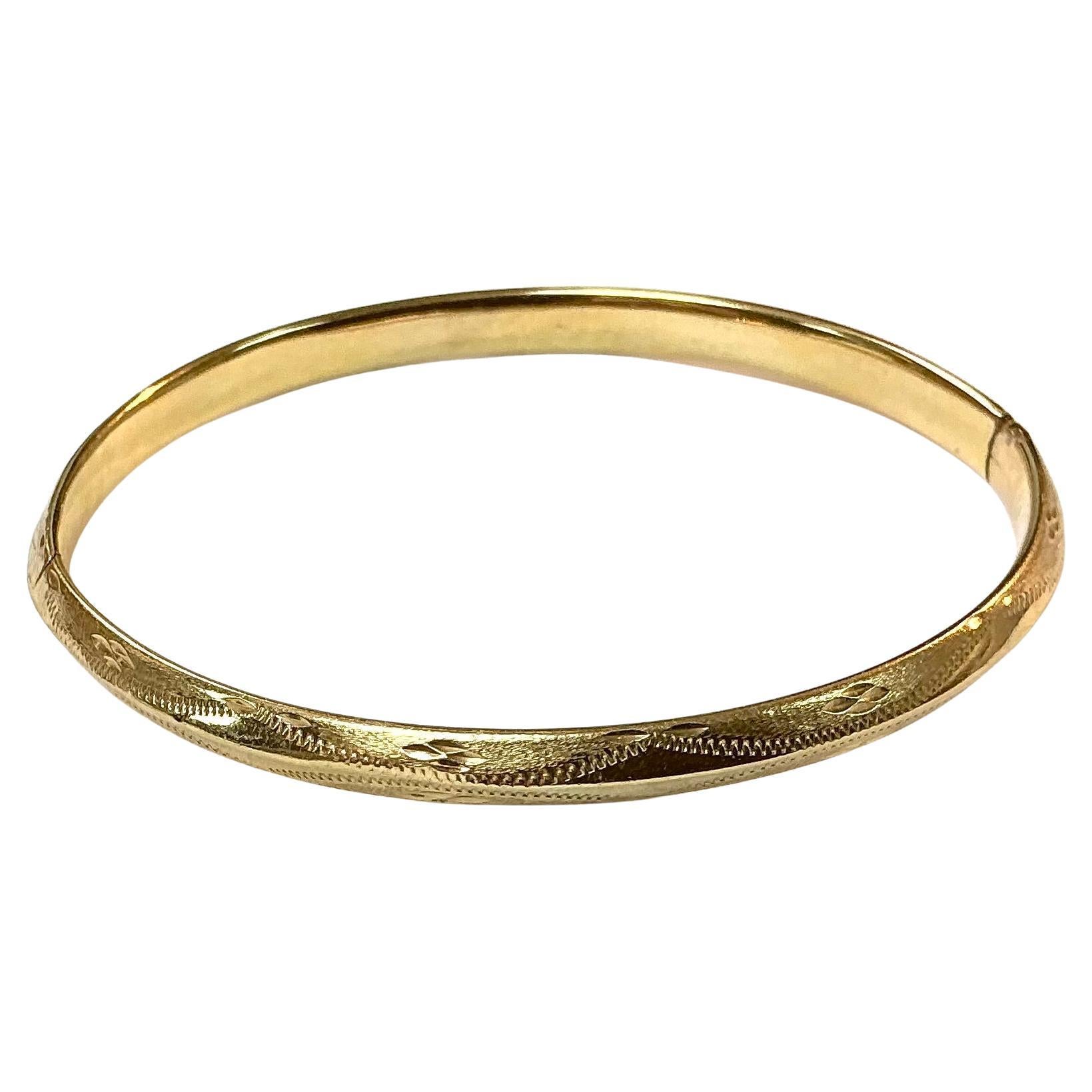 This timeless bangle bracelet is made of 14 karat yellow gold. It has a wonderful warm glow and a weight of 5.29 grams. The bracelet is marked at its closure 14K. This lovely bangle is versatile and a real vintage statement piece.

The condition of