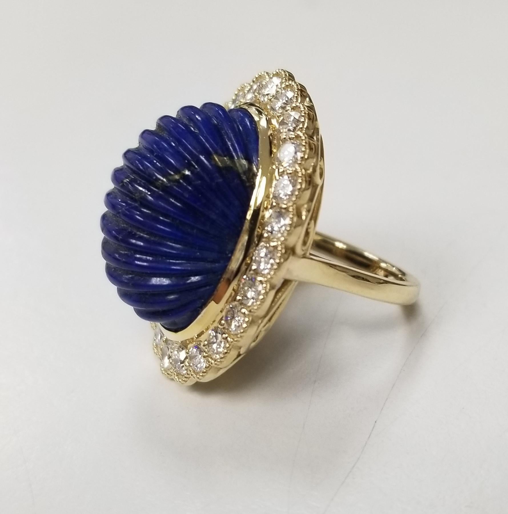  This is an 14k Yellow gold Lapis lazuli and diamond ring. The main stone has the beautiful carved Lapis lazuli and is 28.60 carat weight. It has a 24pcs round diamonds and has an approximately 2.35 carat total weight, G color and VS2 clarity. Its