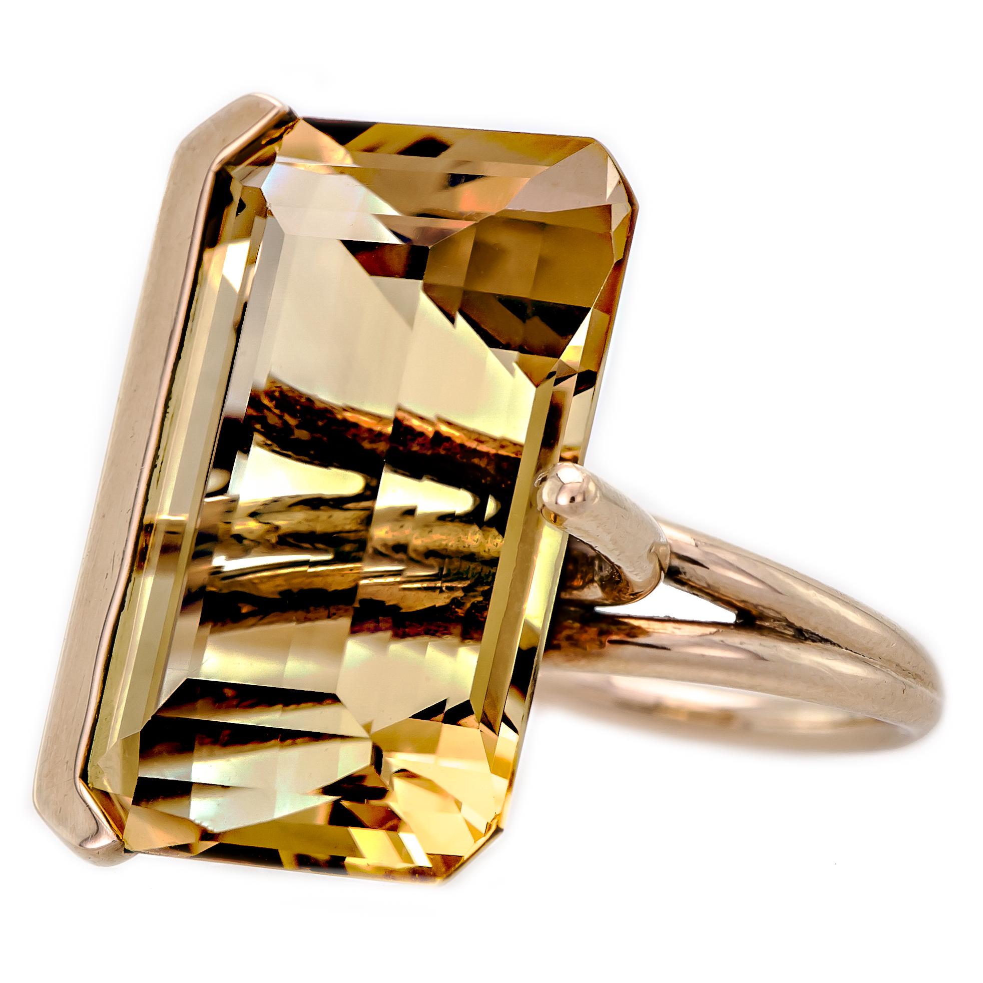Vintage 14kt yellow gold and citrine cocktail ring containing one octagonal step-cut citrine measuring approximately 26.5mm by 17.4mm by 13.2mm. Stamped 14kt. One small chip to corner of story visible with a loupe. 40.32 cts approximately by