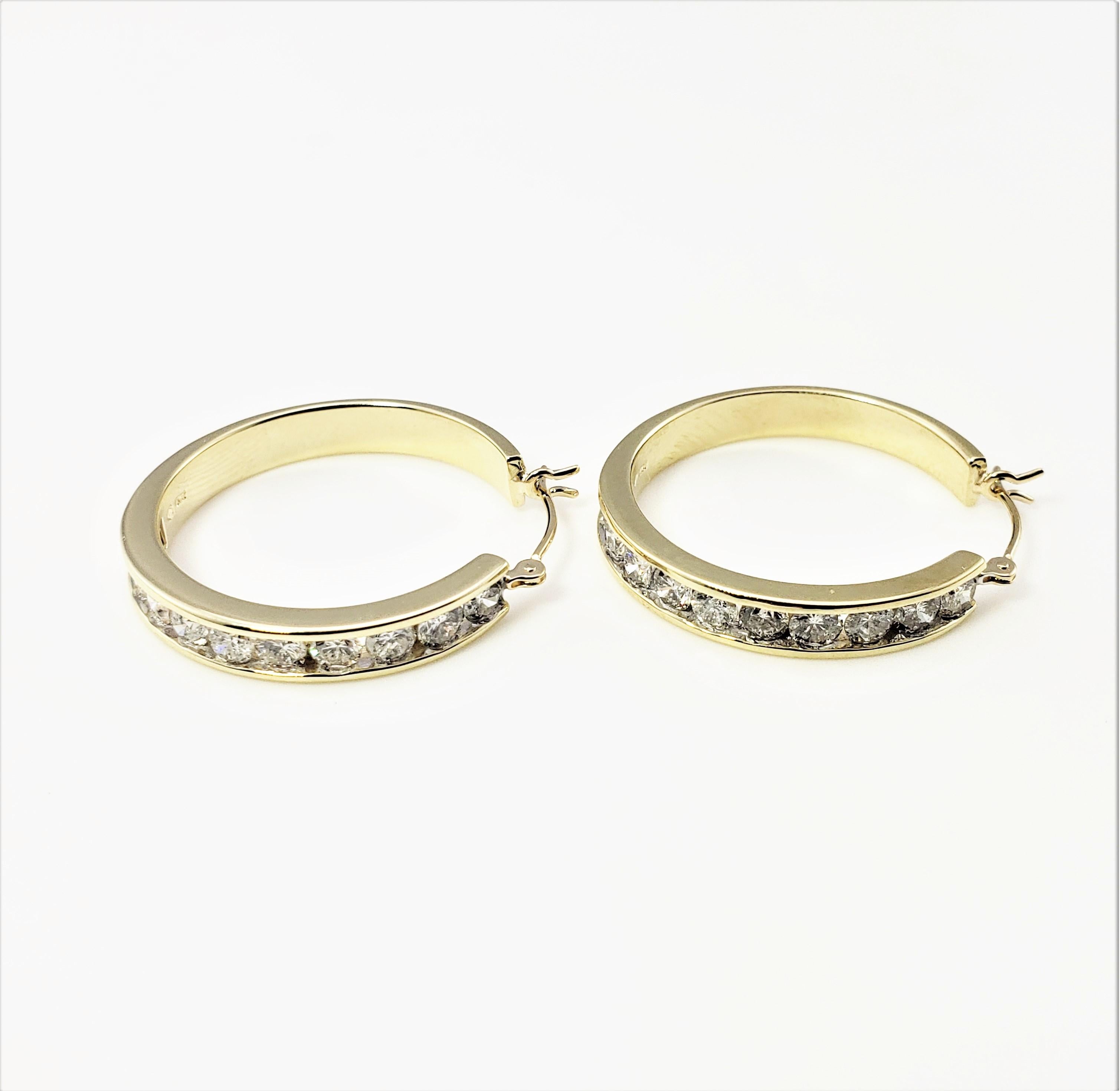 Vintage 14 Karat Yellow Gold Diamond Hoop Earrings-

These sparkling hoop earrings each feature ten round brilliant cut diamonds set in beautifully detailed 14K yellow gold. Width: 4 mm.

Approximate total diamond weight: 1.40 ct.

Diamond color: