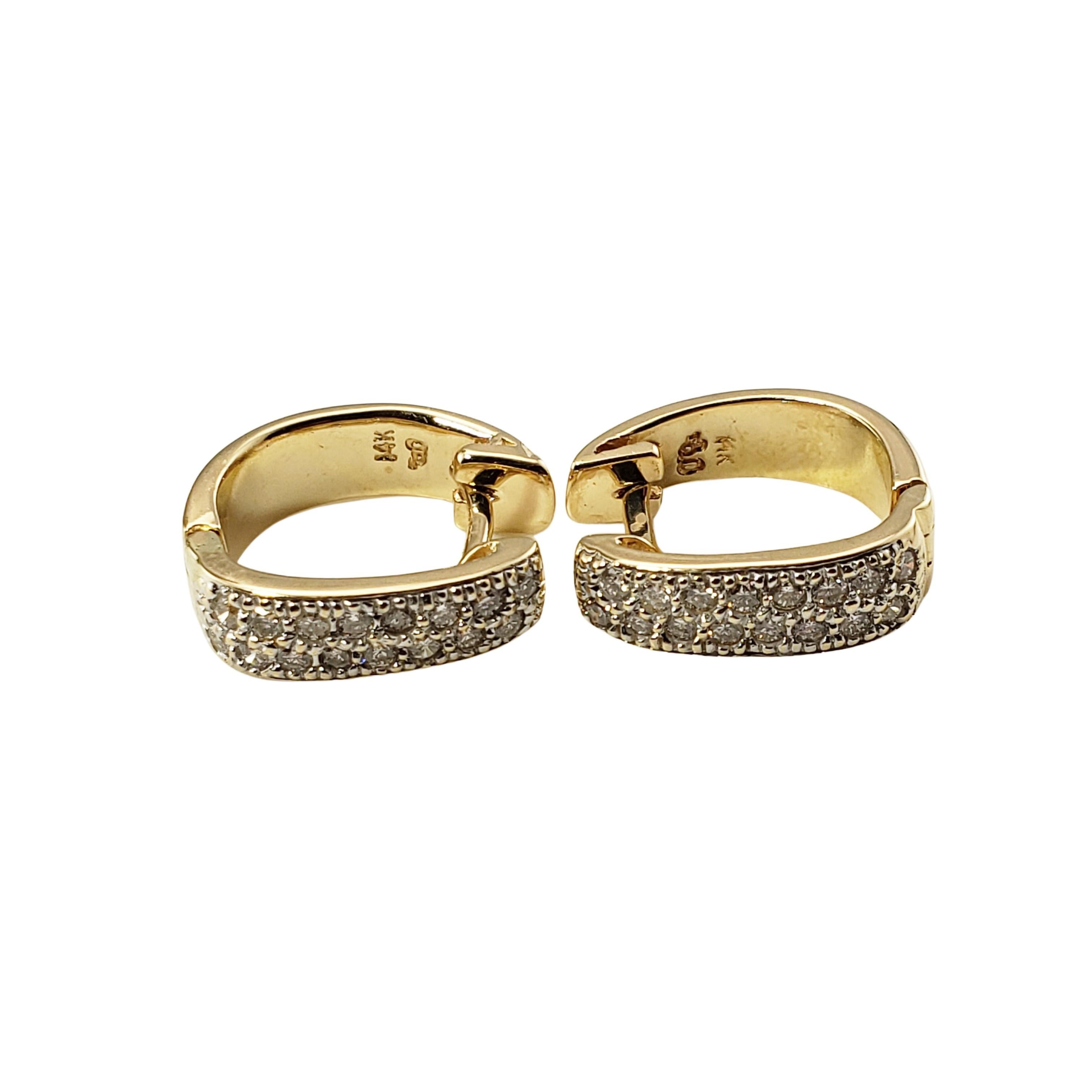14 Karat Yellow Gold and Diamond Hoop Earrings-

These sparkling hinged hoop earrings each feature 16 round brilliant cut diamonds set in classic 14K yellow gold.

Approximate total diamond weight:  .60 ct.

Diamond color: H-I

Diamond clarity: