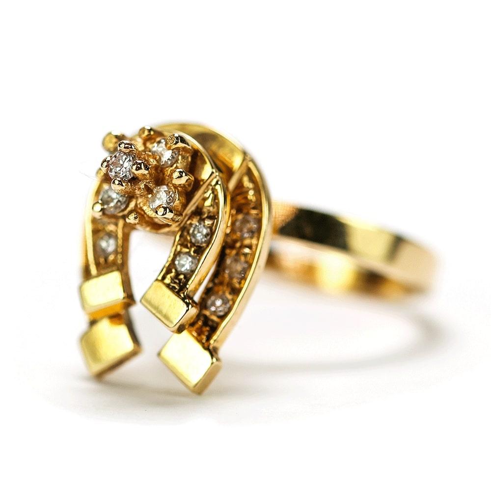 A very unique and unusual ring which we believe was originally from the USA. It is made of 14 karat yellow gold with two diamond set horseshoes with a neat cluster on the top. It is then set on a gimbal so the horseshoes move as you wear the ring.