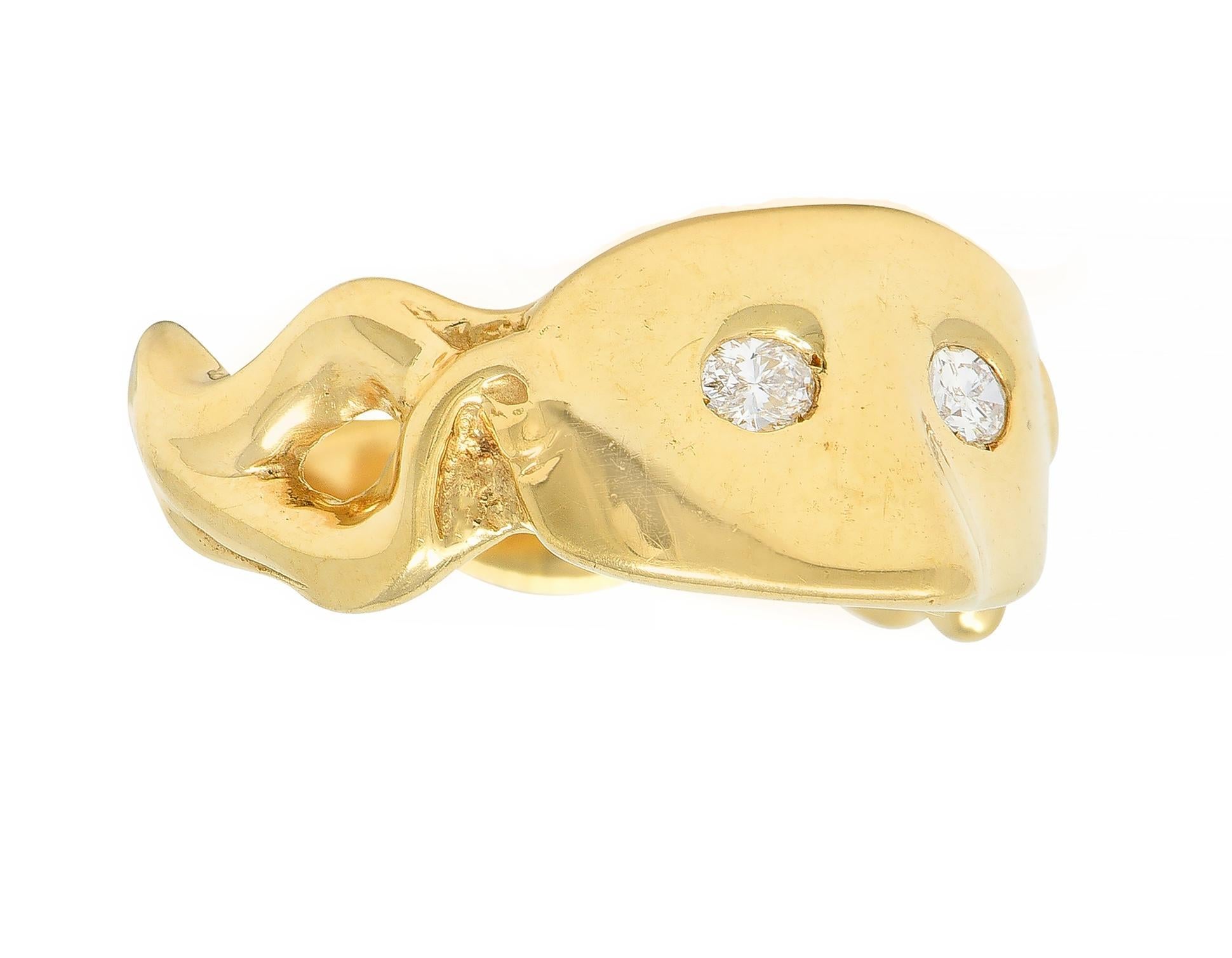 Designed as a stylized Masquerade mask with oval diamond eyes
Weighing approximately 0.22 carats total - F/G color with VS clarity
Completed by high polish stylized ribbon shoulders
Stamped for 14 karat gold 
With maker's mark 
Circa: 1960s
Ring