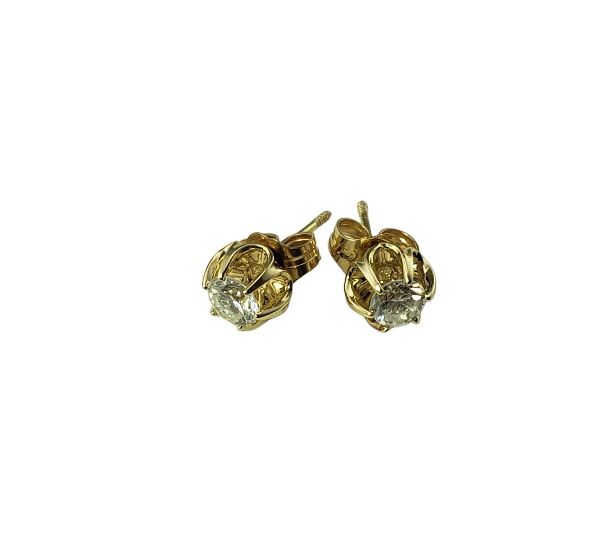 Vintage 14 Karat Yellow Gold Diamond Earrings-

These sparkling stud earrings each feature one round brilliant cut diamond set in beautifully detailed 14K yellow gold.  Screw back closures.

Approximate total diamond weight:  .40 ct.

Diamond