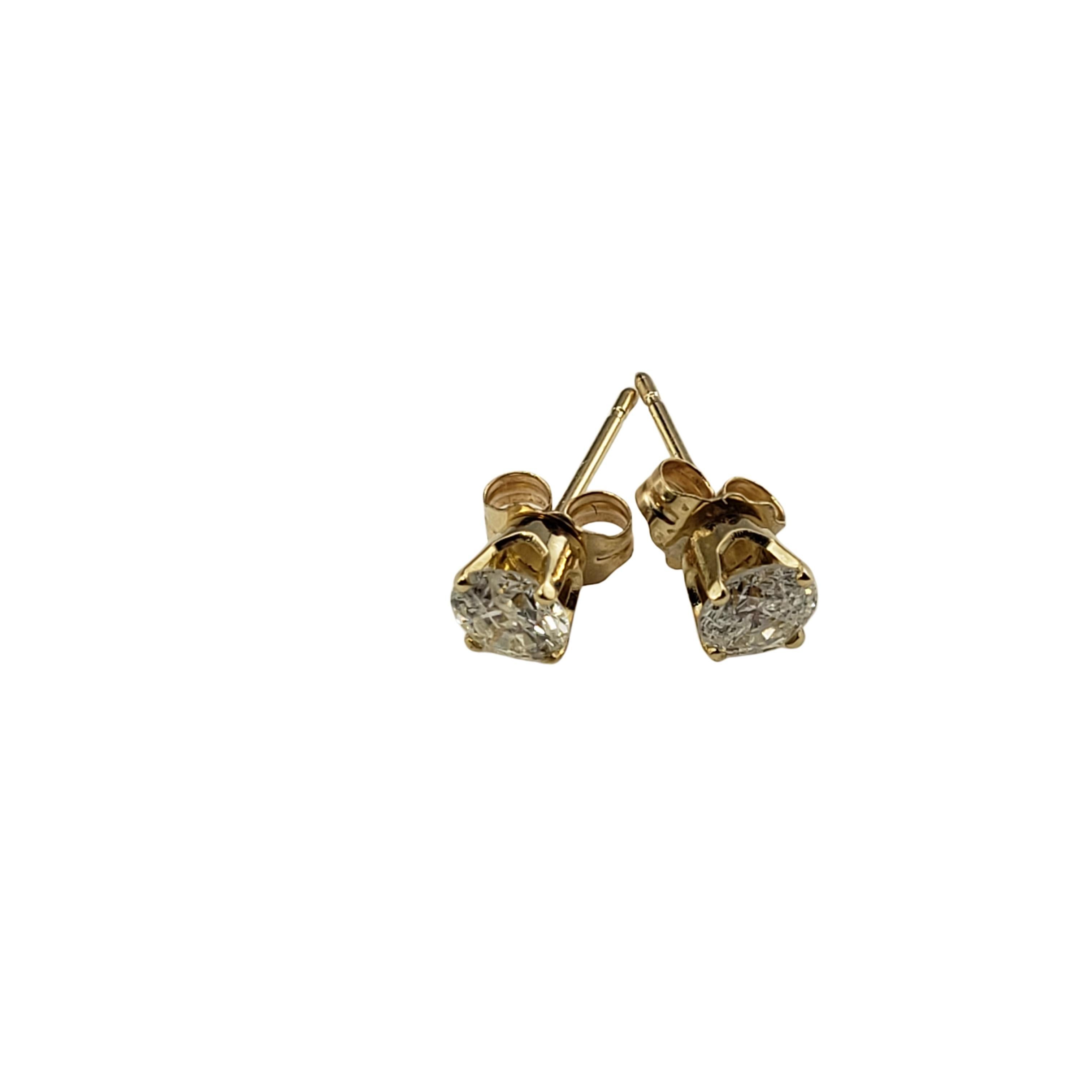 Vintage 14 Karat Yellow Gold Diamond Stud Earrings .60 TCW.-

These sparkling earrings each feature one round brilliant cut diamond set in classic 14K yellow gold.  Push back closures.

Approximate total diamond weight:  .60 ct.

Diamond color: