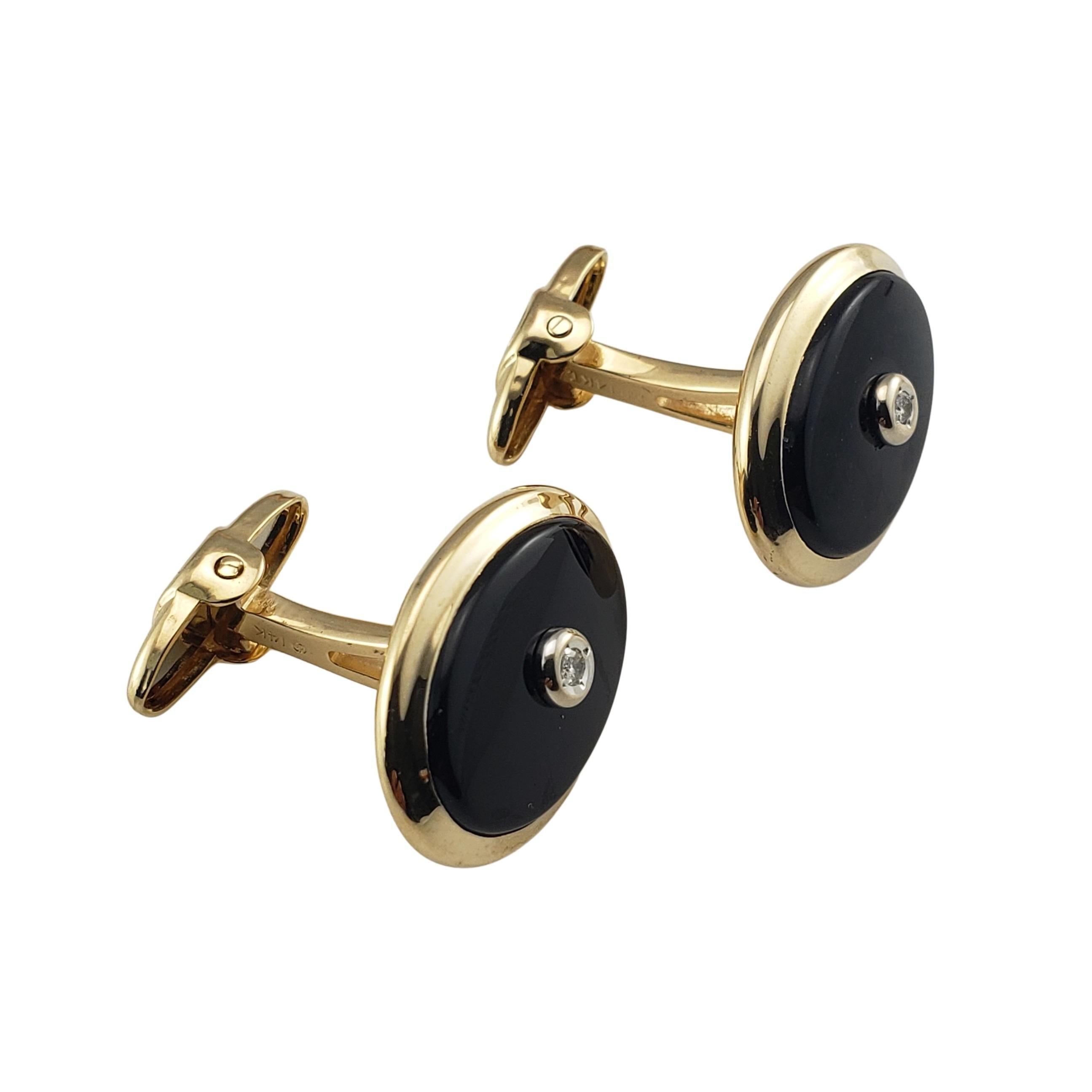 Vintage 14 Karat Yellow Gold Dolan Bullock Onyx and Diamond Cufflinks-

These elegant onyx cufflinks are each accented with one round brilliant cut diamond and set in classic 14K yellow gold.

Approximate total diamond weight:  .06 ct.

Diamond