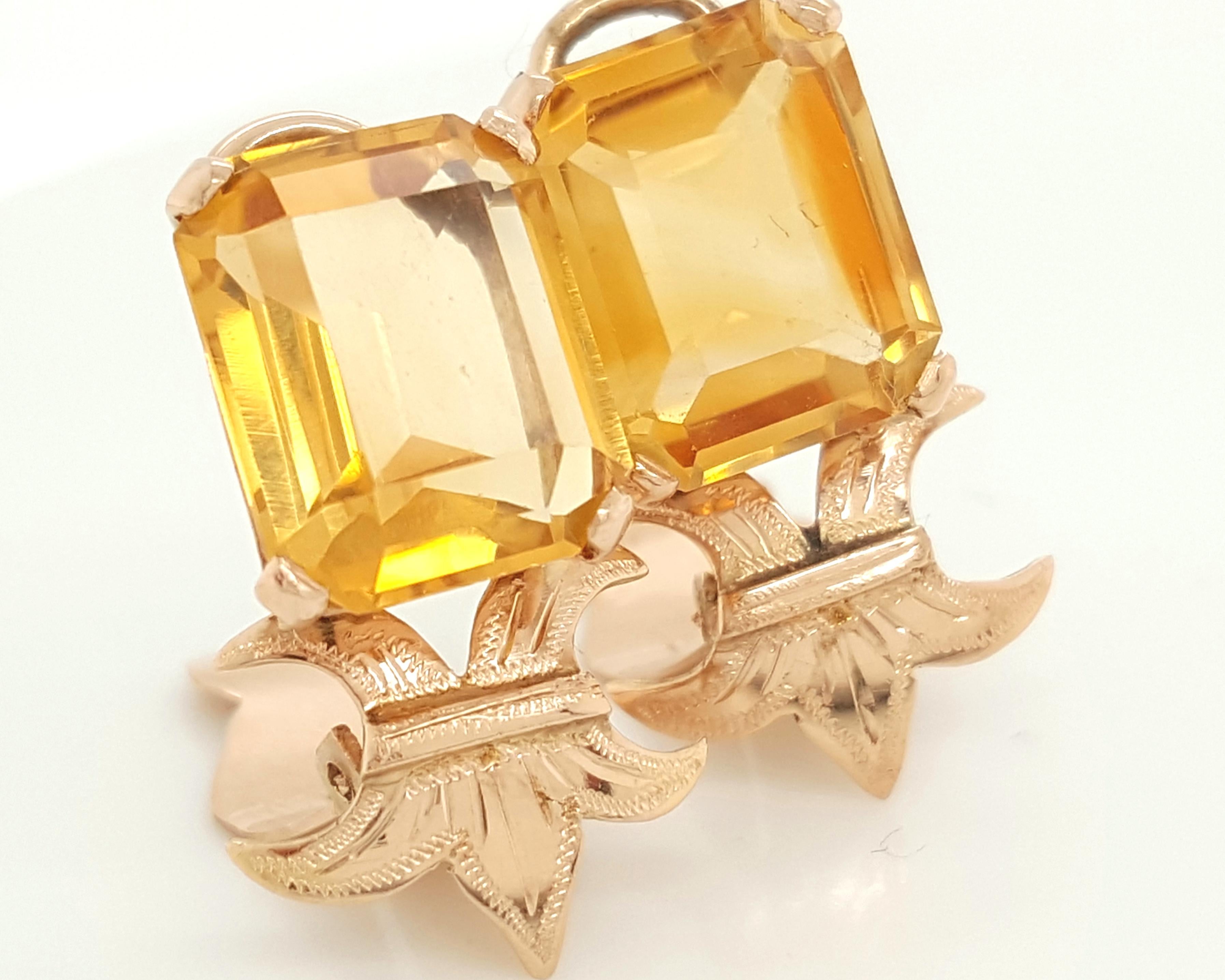 14 Karat Yellow Gold Emerald Step Cut Citrine Ear Clips. These tailored and unique earrings feature a matched pair of step cut shaped citrine weighing approximately 6.8 carats total weight. The citrine are each set into a 14 karat yellow gold four