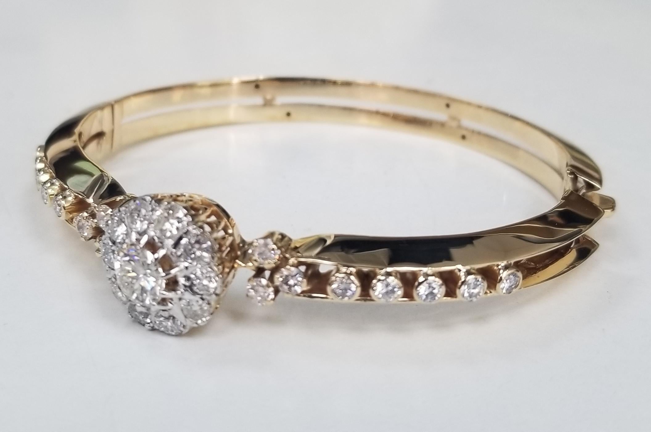 Vintage 14 Karat Yellow Gold Handmade Diamond Bangle Bracelet, containing 
Specifications:
    main stone: ROUND CUT DIAMONDS
    carat total weight: center diamond .77pts. color H and clarity SI2
   additional diamonds; 26 round diamonds weighing