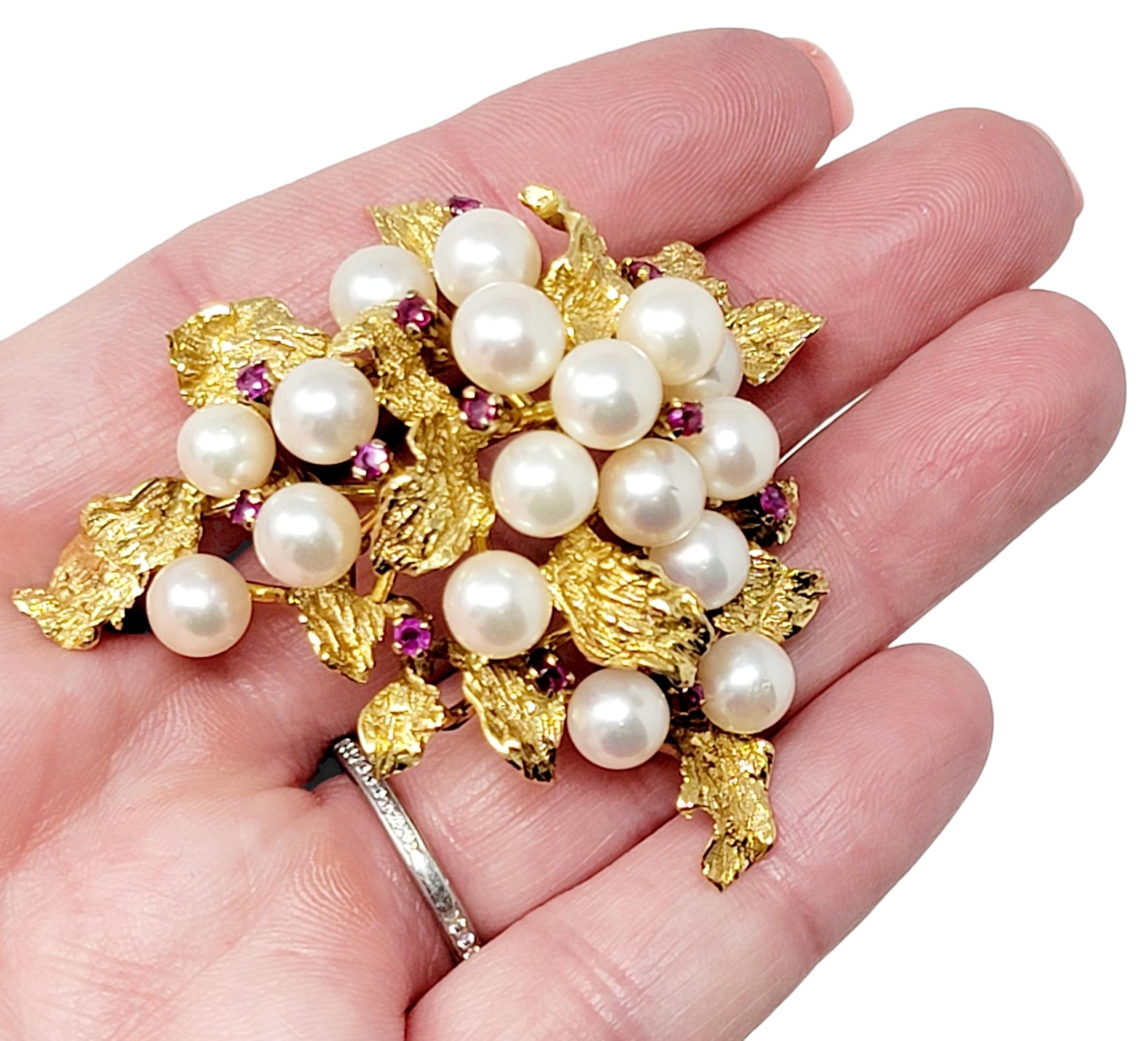 Exquisite vintage pearl and ruby brooch will elevate any item it is paired with. The ultra feminine design absolutely radiates, offering sparkle, shine and sophistication. This gorgeous brooch is made of 14 karat yellow  gold and arranged in a