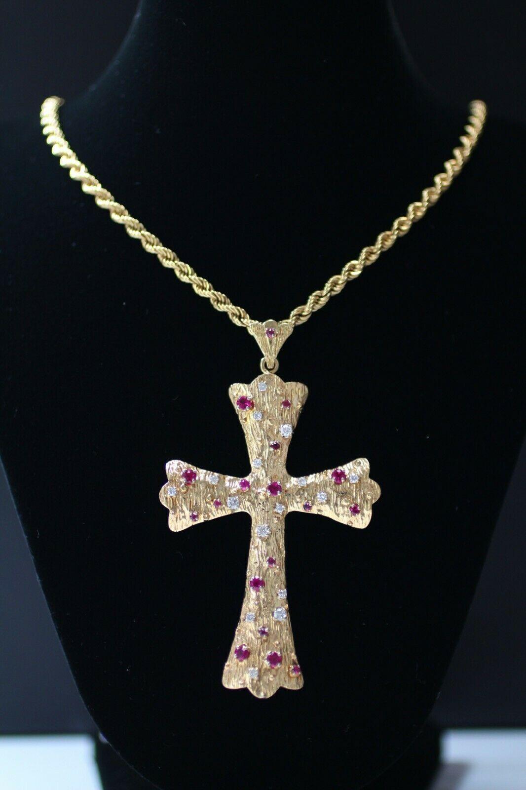  14k yellow gold large ruby and diamonds cross and chain, containing 
Specifications:
    PENDANT : CROSS PENDANT  32.40
    diamonds: ROUND CUT DIAMOND 16 PIECES 0.65ctw 
    stone: round cut ruby stone 1.10 ctw
    carat total weight: 1.75 ctw
   