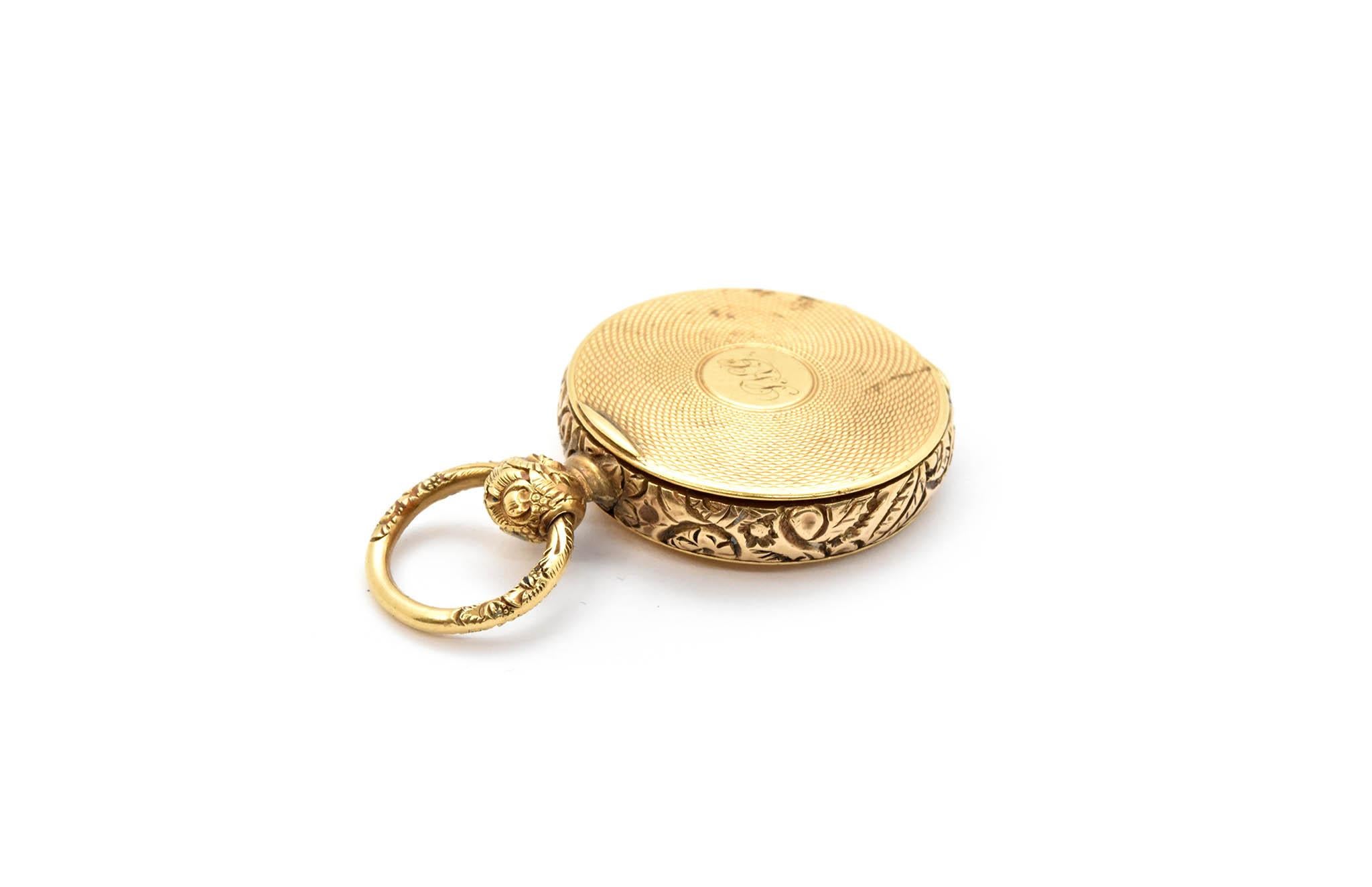 This locket is made in 14k yellow gold. It measures 26mm wide and 42mm tall. The piece weighs 17.93 grams. The front of the locket is monogrammed.