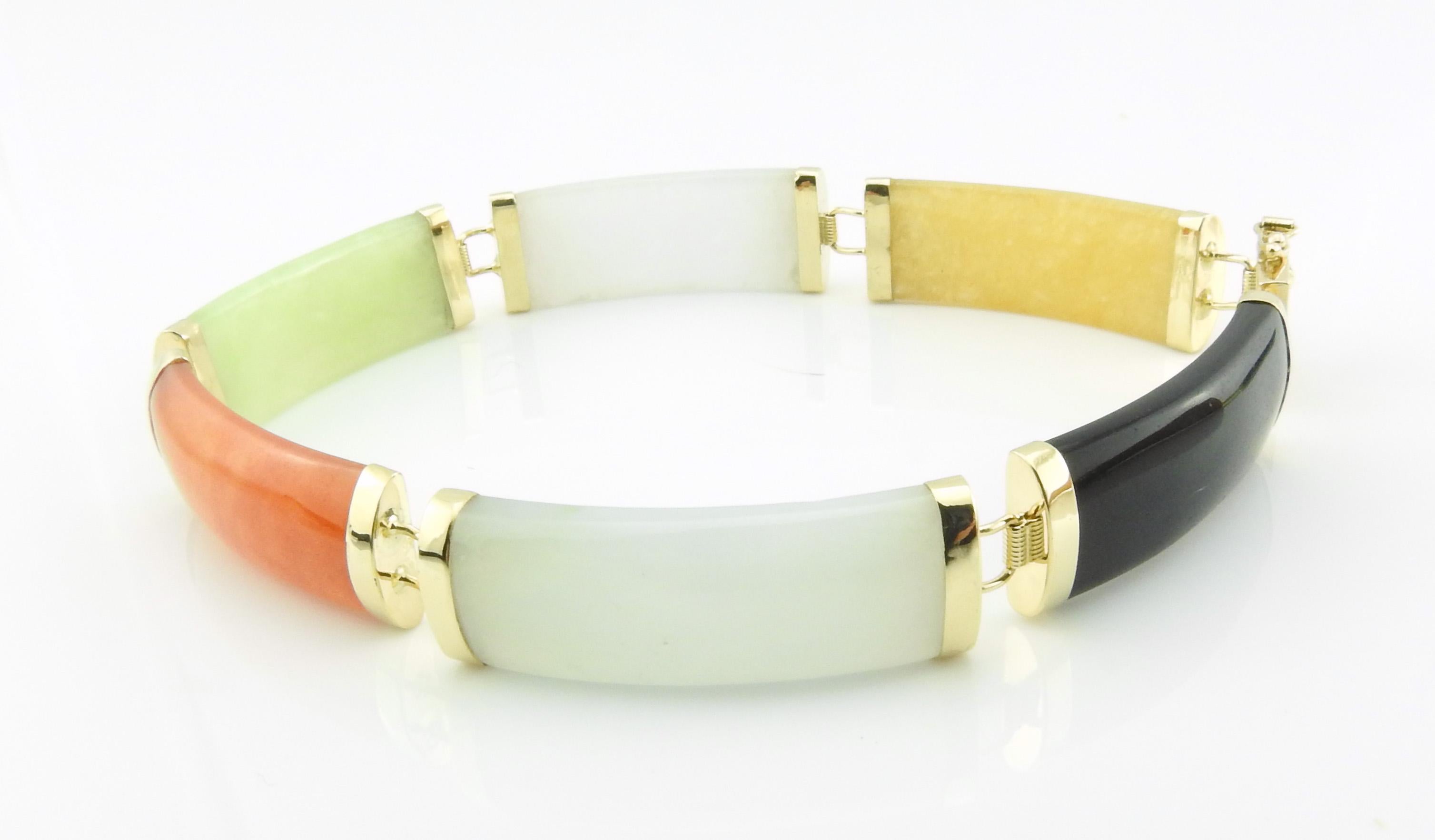 This lovely bracelet showcases six jadeite links (black, grey, coral, white, pale green and amber) each capped with polished 14K yellow gold. Clasp features Chinese characters for luck.  Perfect accessory for any ensemble!

Bracelet width: 10