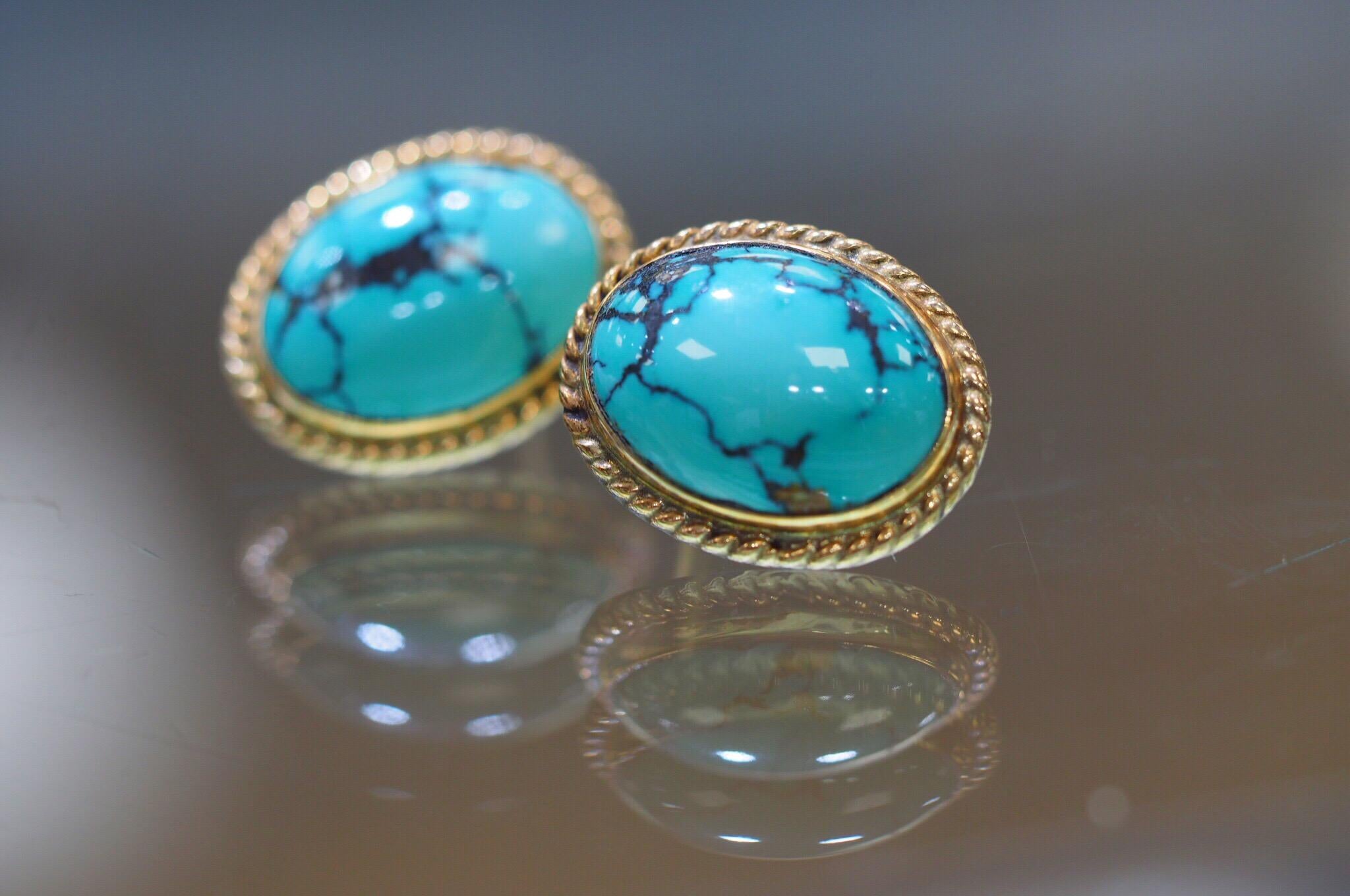 These 14 karat yellow gold push back earrings include bluish-green Oval Cabochon-cut natural turquoise with veins of matrix. 