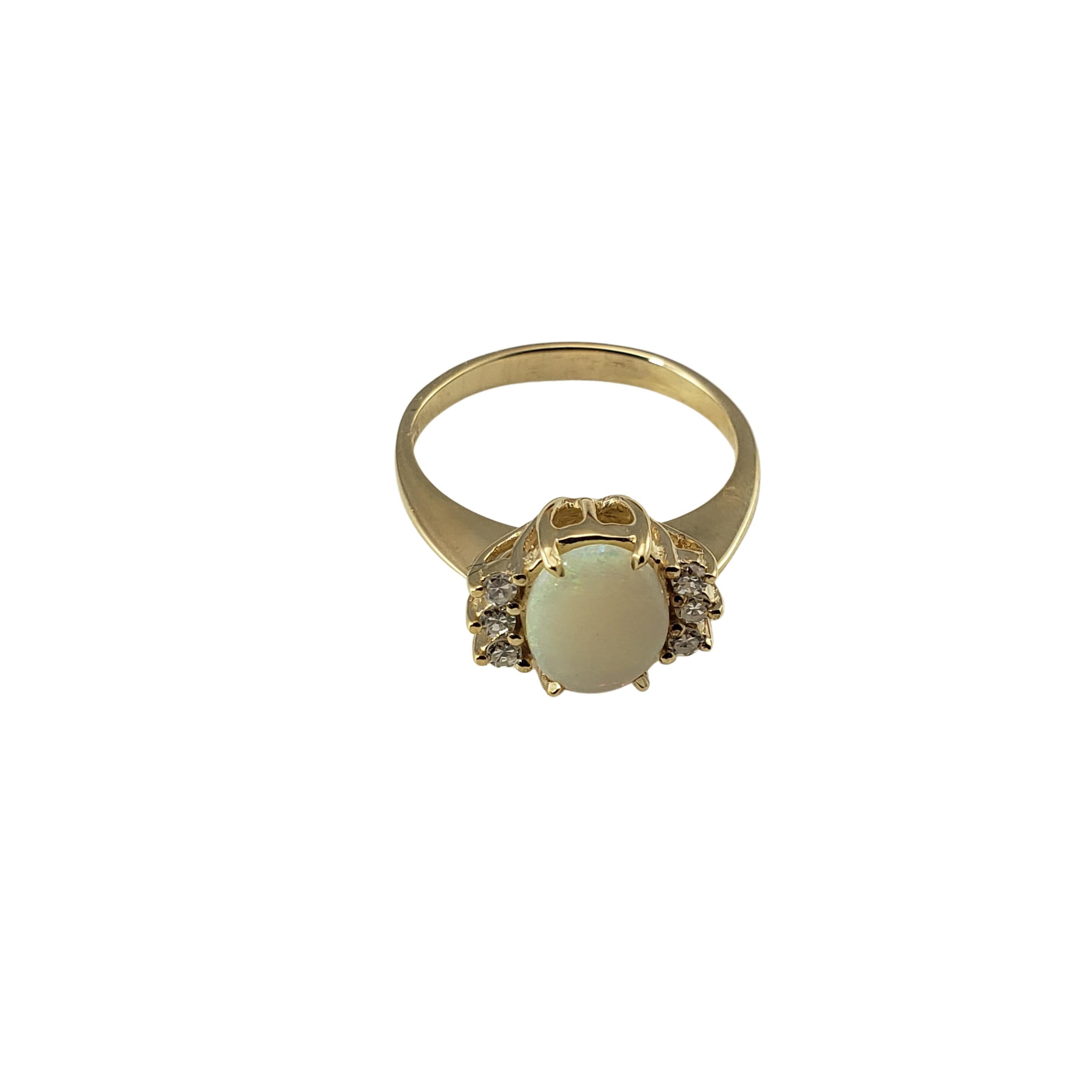 Vintage 14 Karat Yellow Gold Opal and Diamond Ring Size 7.25-

This elegant ring features one oval opal (9 mm x 7 mm) and six round single cut diamonds set in classic 14K yellow gold.
Shank: 2 mm.

Approximate total diamond weight: .10 ct.

Diamond