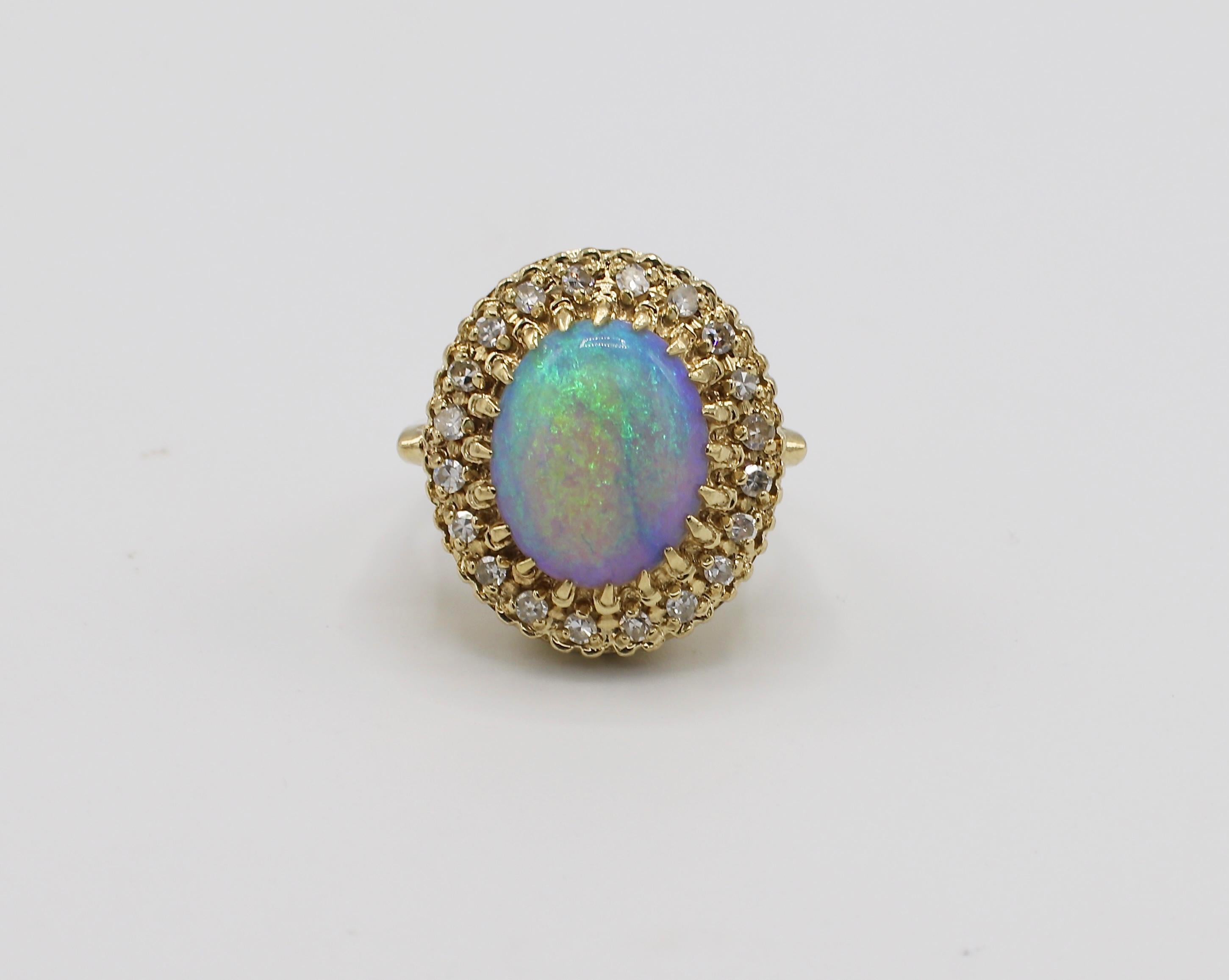 Vintage 14K Yellow Gold Opal & Diamond Halo Cocktail Ring Size 3
Metal: 14k yellow gold
Weight: 5.65 grams
Opal Cabochon: 11 x 9.5, no crazing 
Diamonds: Approx. .20 CTW G-H VS round single cut diamonds
Size: 3
Top of ring measures 18.2 x 16.4MM

