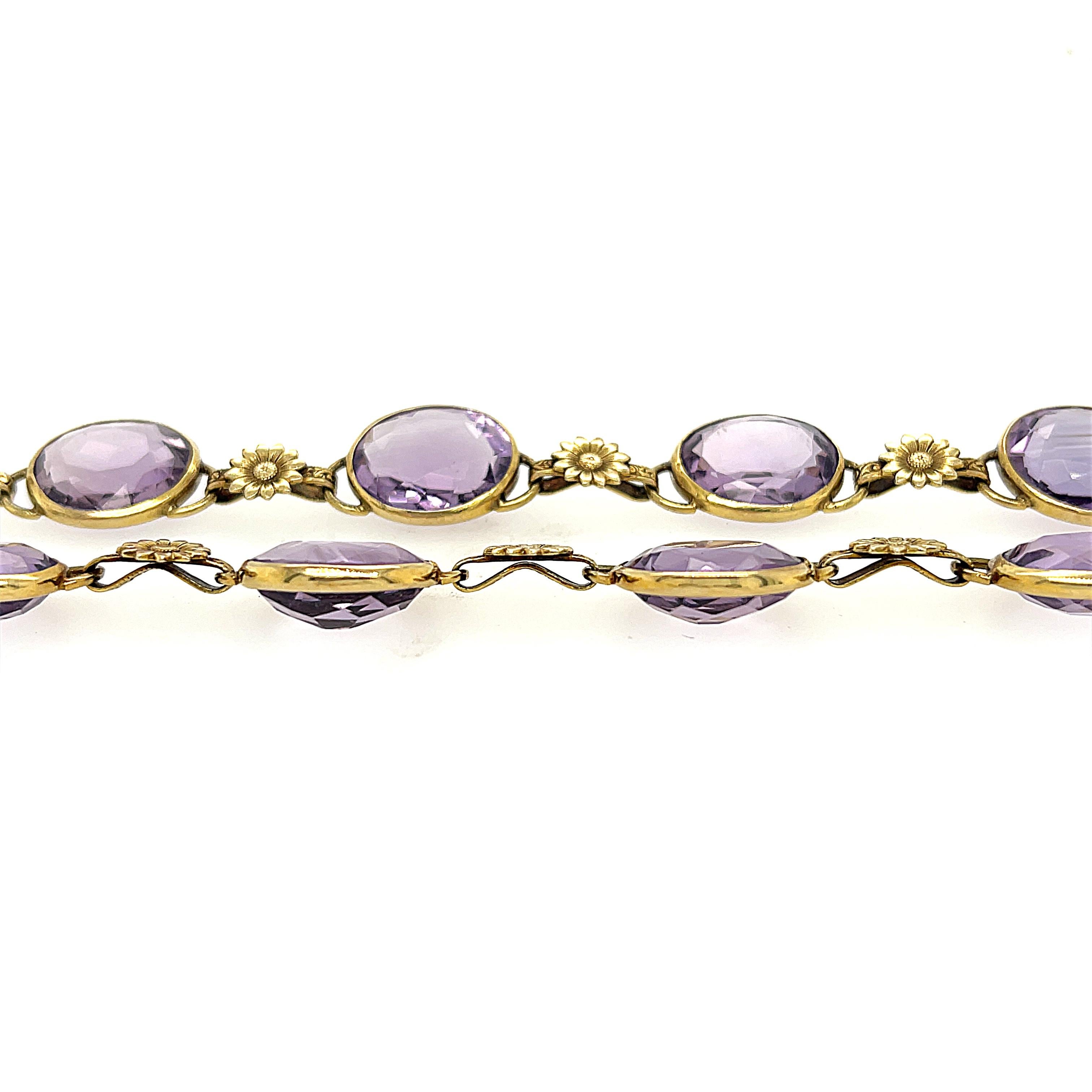 A pretty pastel colored amethyst necklace with gold sunflower spacers set in 14k gold, circa 1950. This happy necklace is set with gorgeous pinky purple amethysts with gold sunflowers in between. The necklace is 16 inches long with a tongue clasp. 