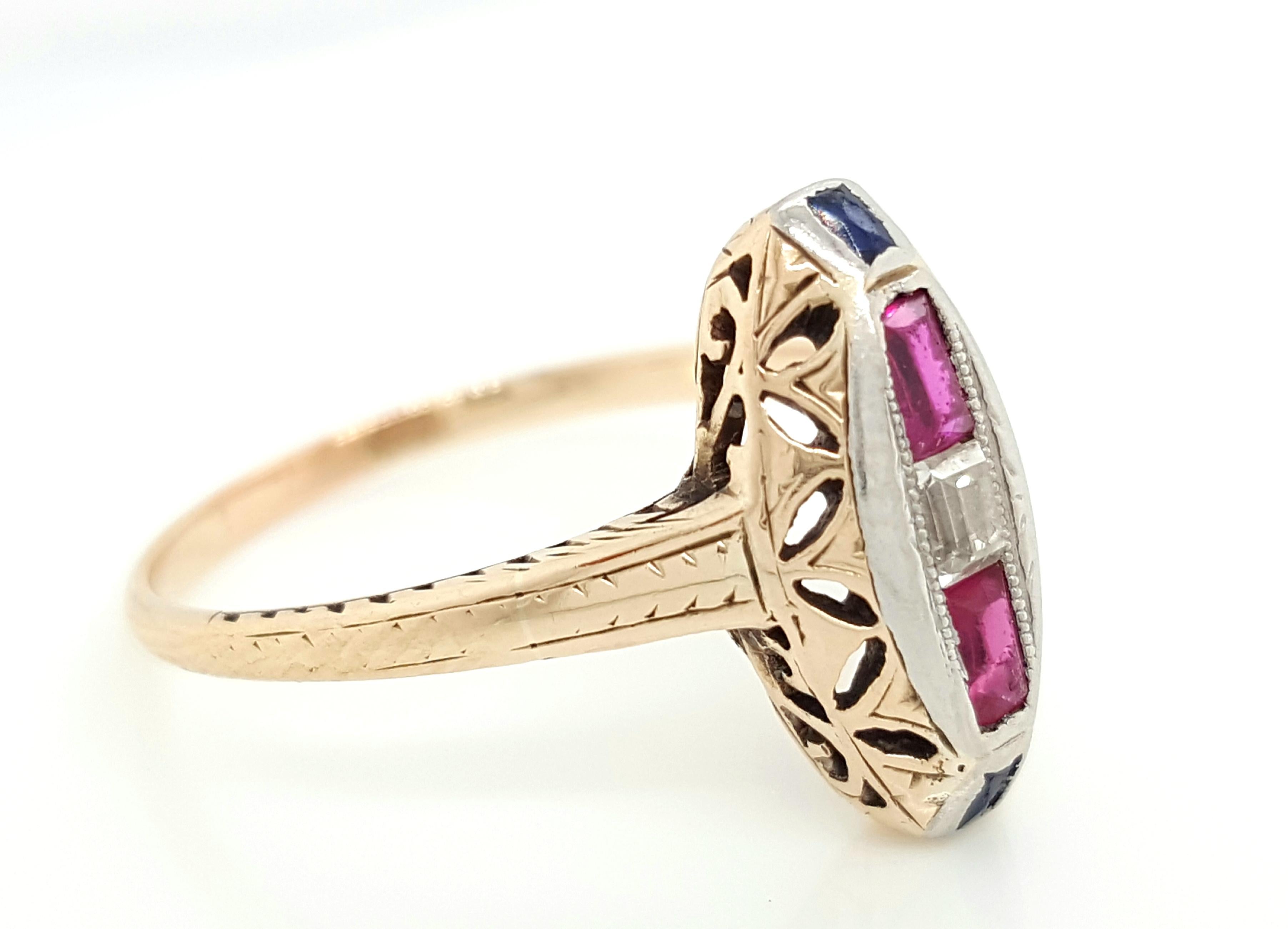 This is an exquisite example of a Victorian Navette marquise-shaped ring. It is crafted in yellow gold and the center features 2 blood red rubies of the finest quality, 2 Sapphires and 1 Emerald Step Cut diamond. This would make an excellent