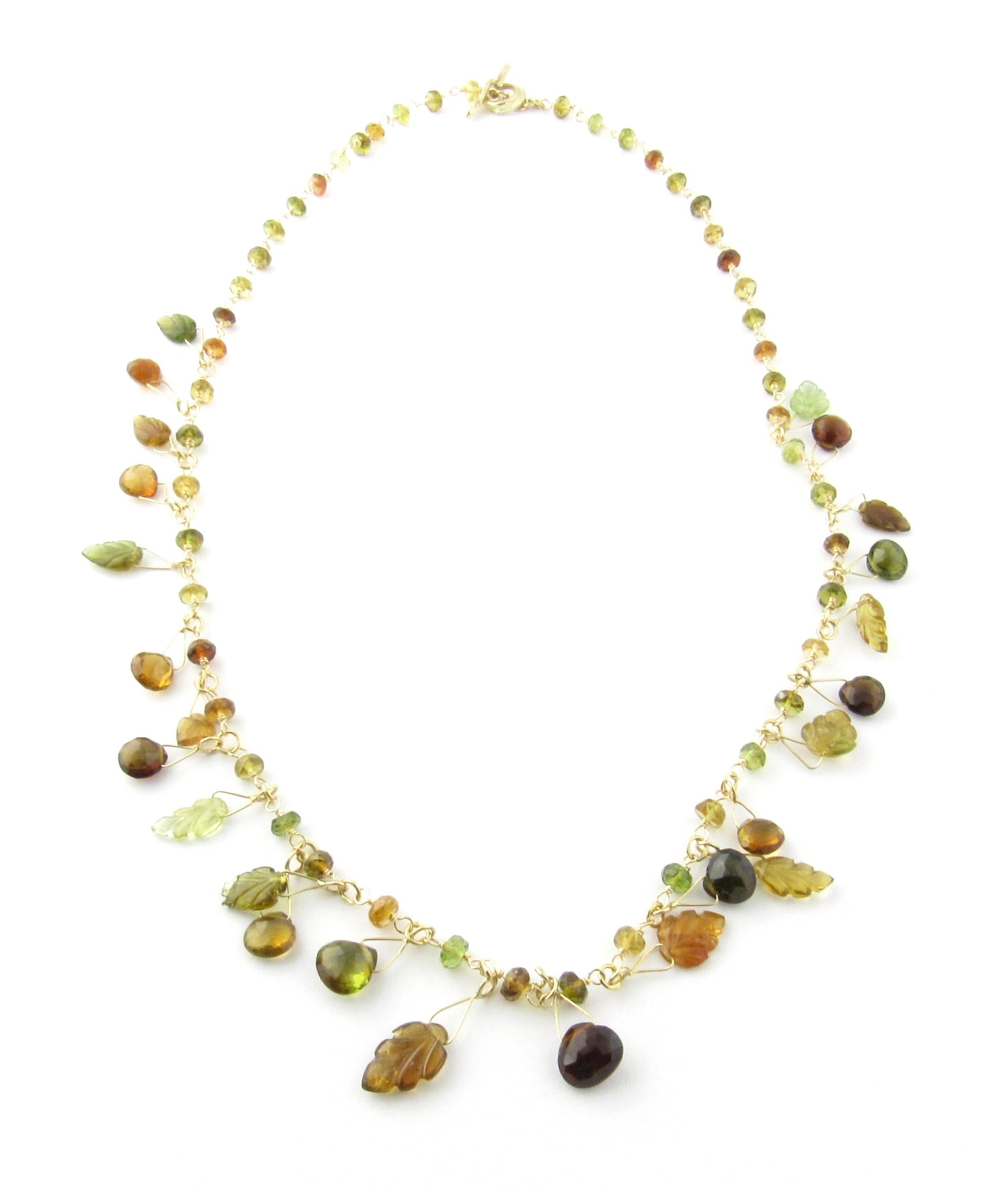 -

This unique necklace features dangling amber stones and glass leaves on a lovely 14K yellow gold necklace with a leaf design toggle closure.

(Note: One leaf bead has superficial chip.)

Size:  16.5 inches

Weight: 3.9 dwt. /  6.2 gr.

Hallmark: