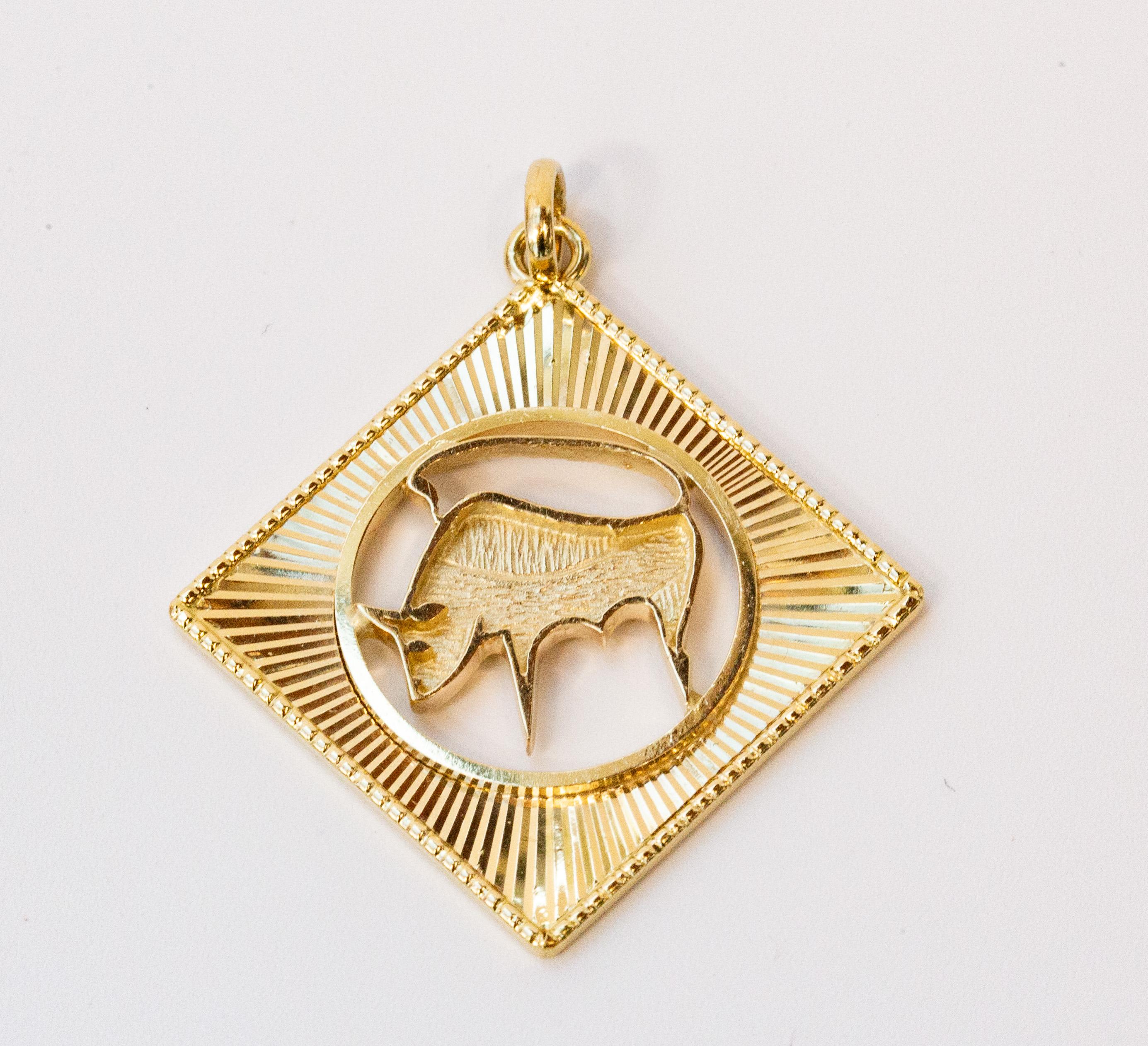 A vintage pendant/charm depicting Zodiac sign: Taurus. The pendant is made of solid 14 karat yellow gold. The pendant is marked with the maker's name 